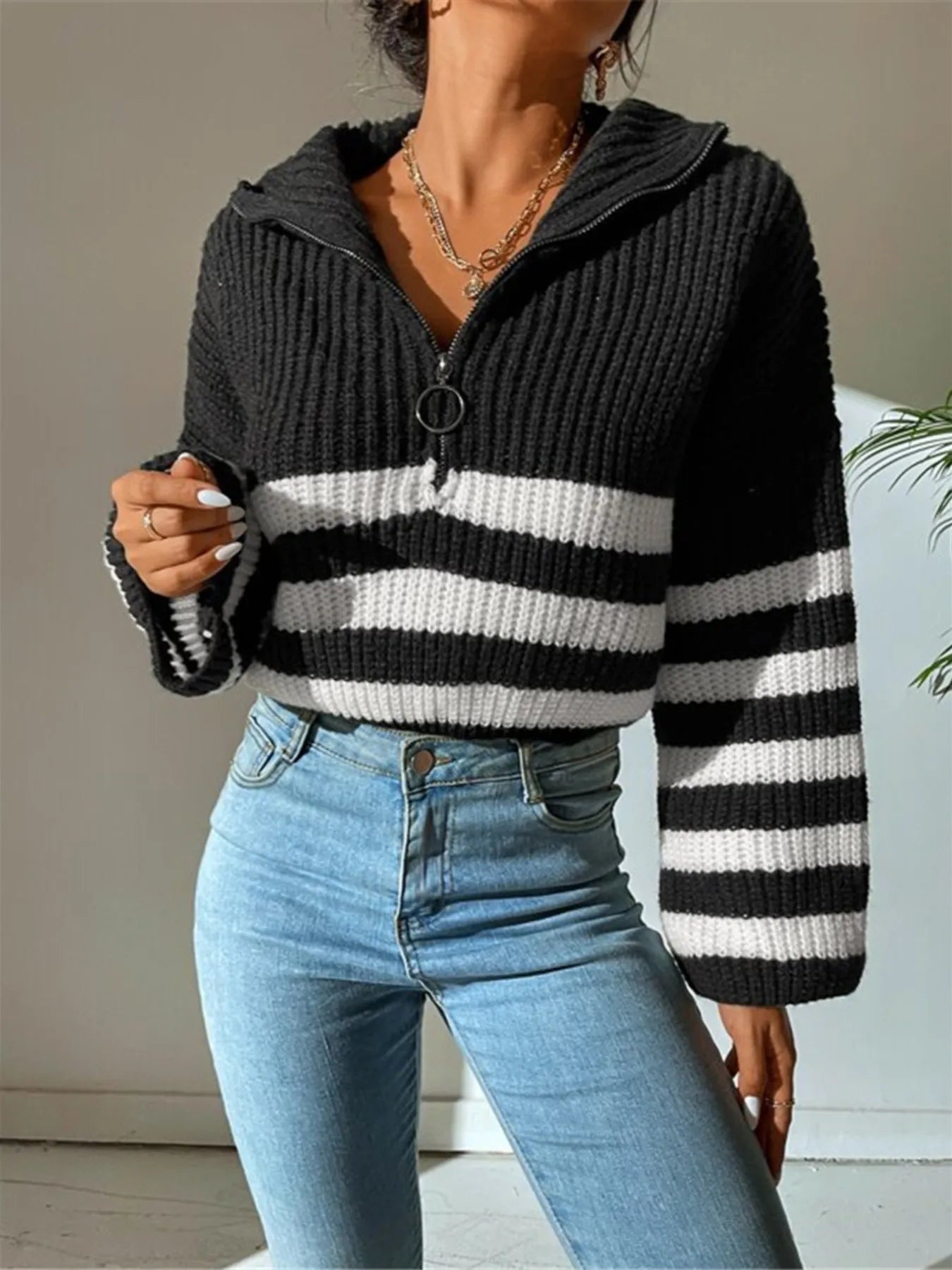 Black ribbed cropped half-zip sweater with white-and-black striped bands