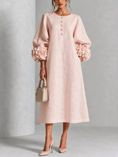 Blush pink midi dress with round neck, button front, and 3D floral puff sleeves