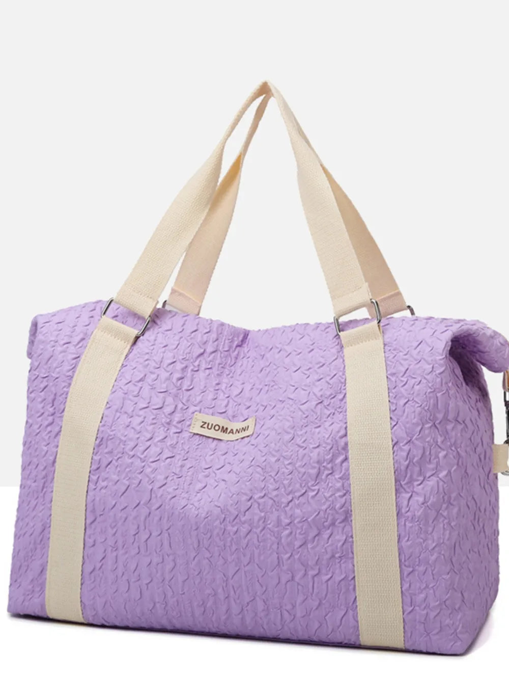 Textured large duffle travel bag with two top handles, purple with tan straps