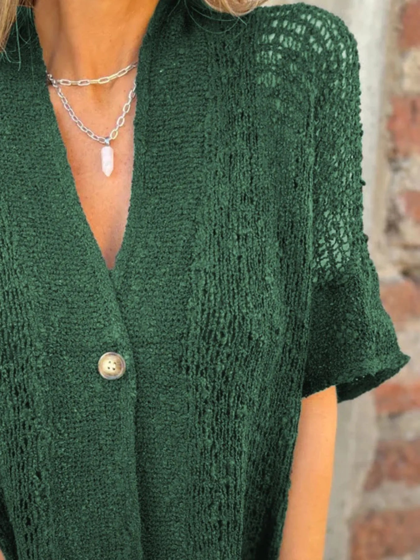 Green one-button openwork cardigan with V-neck and short sleeves, textured knit front