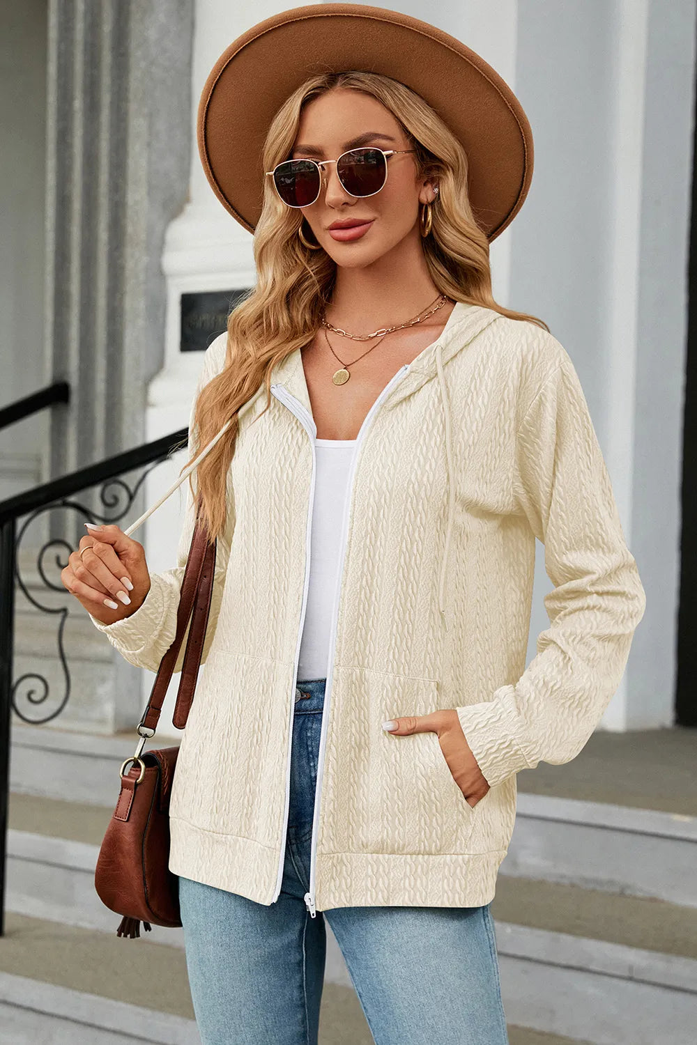 Cream zip-up hoodie with hood and long sleeves, textured knit and front zipper
