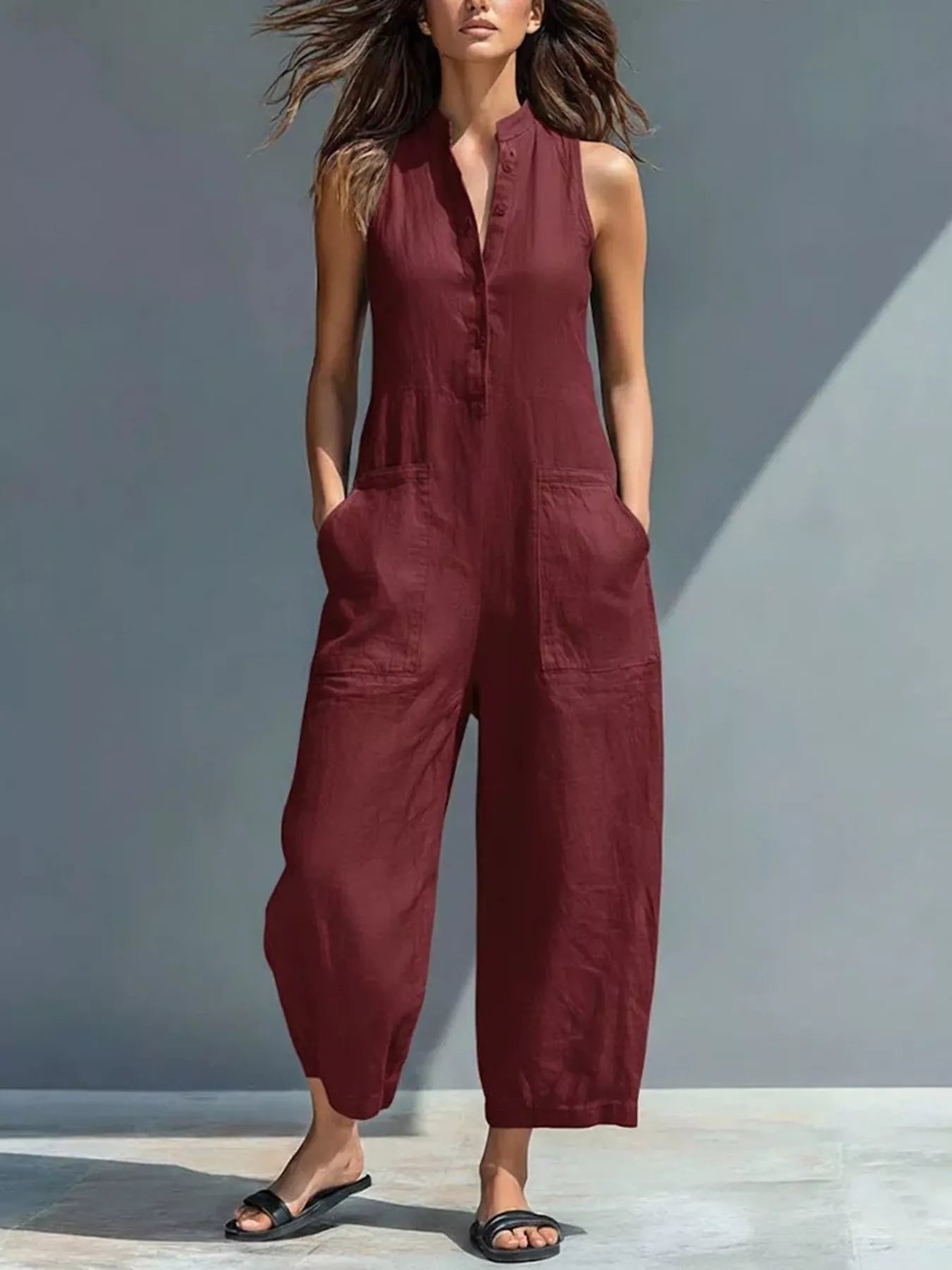 Wine red sleeveless button-front jumpsuit with patch pockets and wide cropped legs