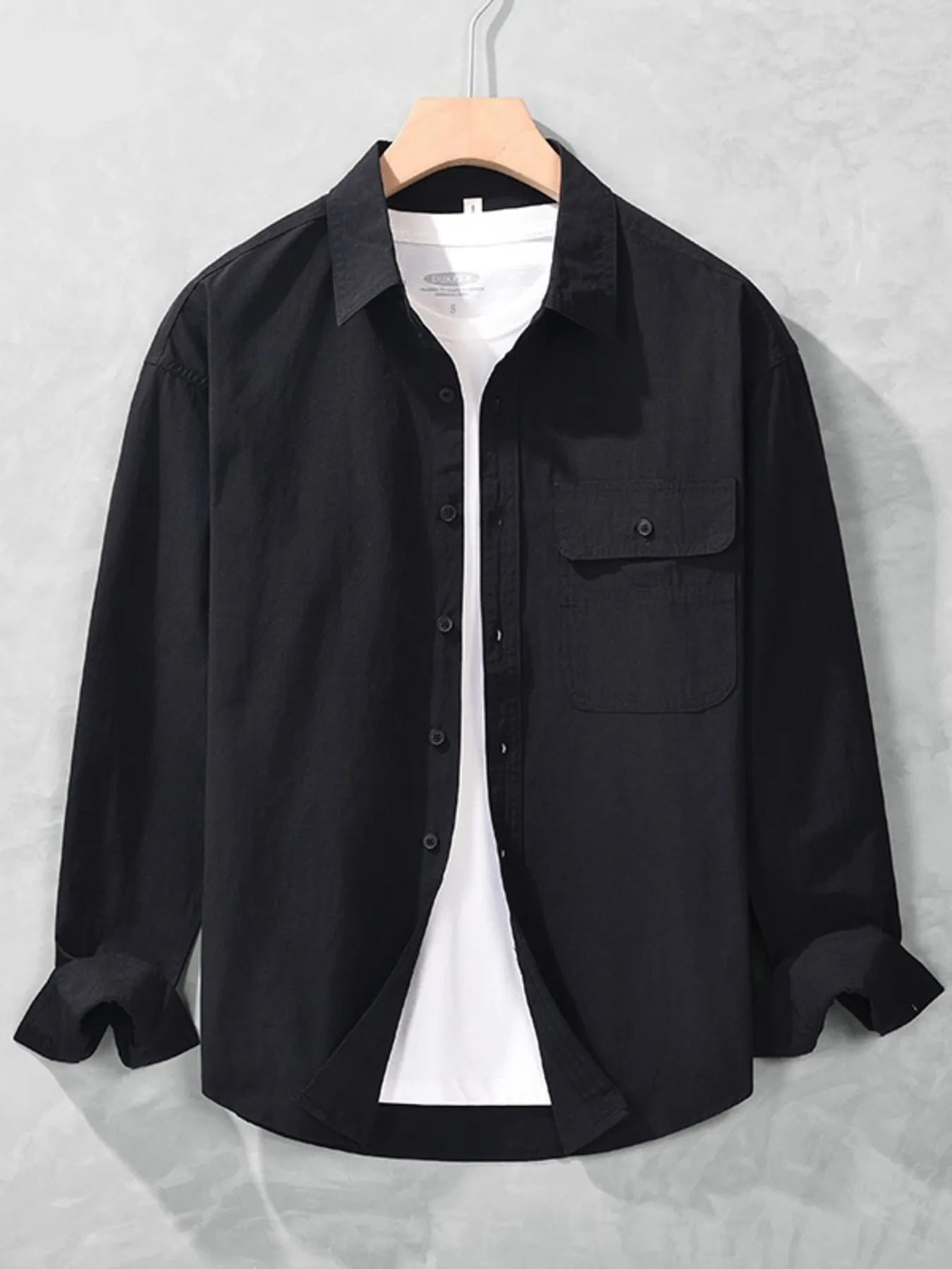 Black button-up long sleeve shirt with chest pocket, button front, and spread collar.