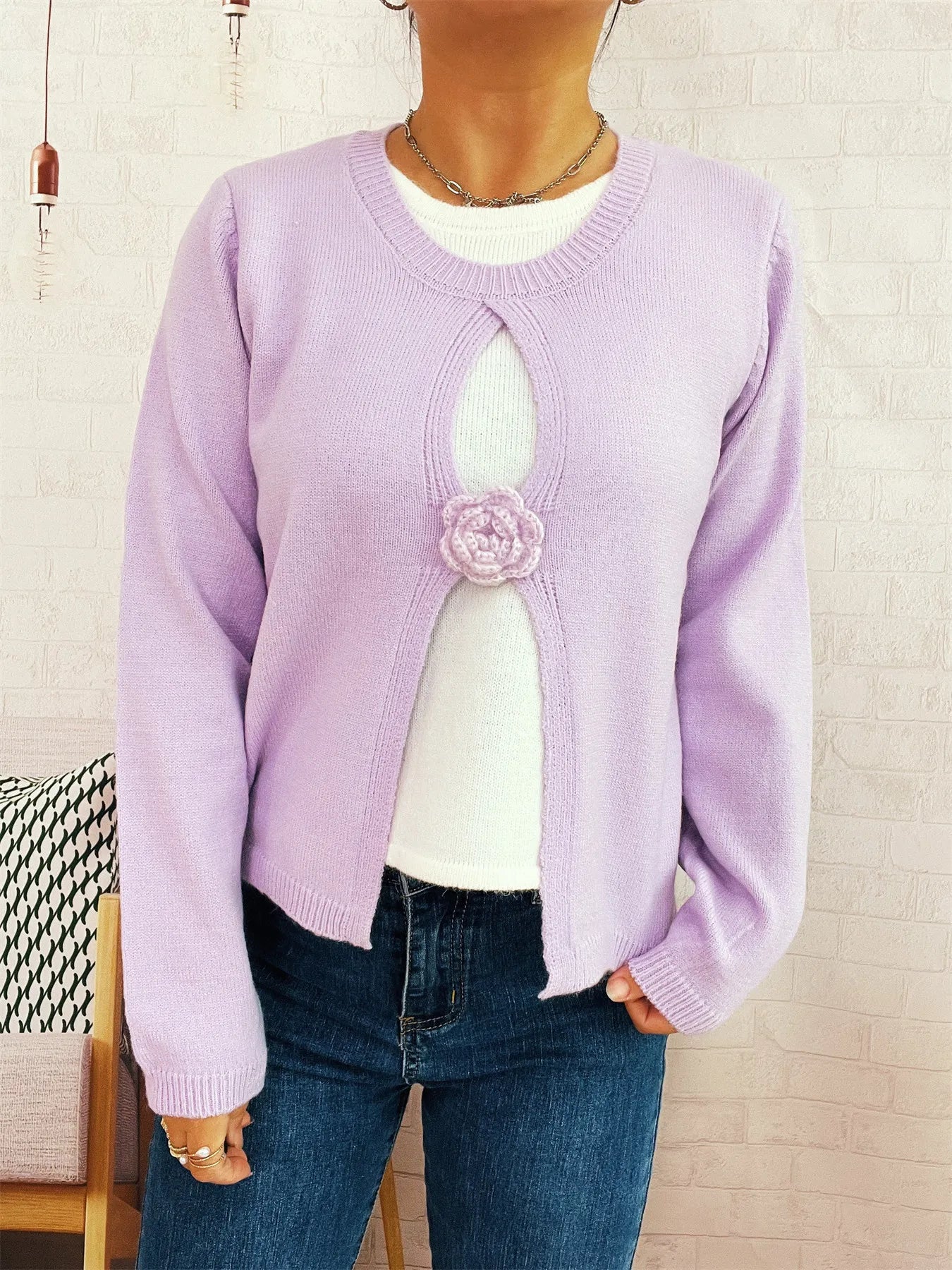 Purple round-neck sweater with white underlayer keyhole and front flower detail
