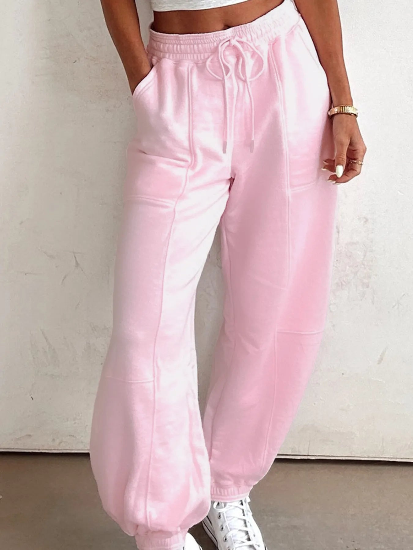 Pink drawstring sweatpants with elastic waist and side pockets