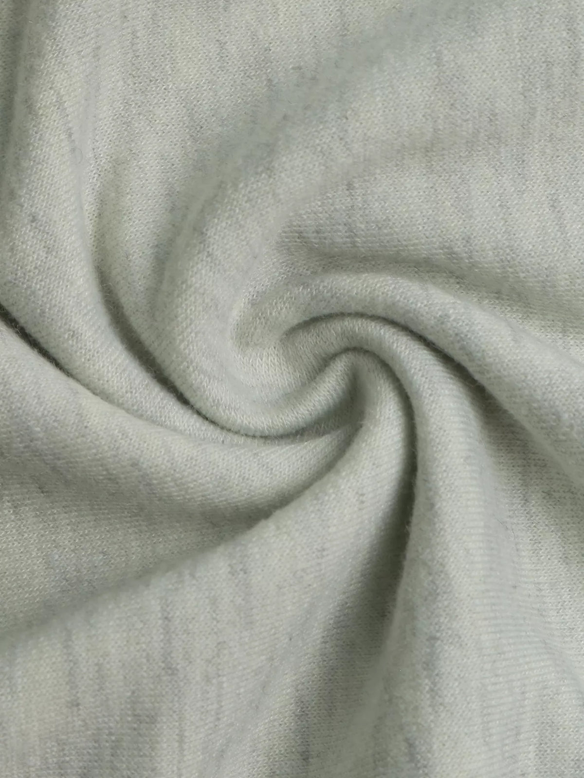 Close-up of light gray soft stretch knit fabric with smooth drape