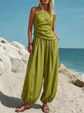 Green one-shoulder sleeveless top and wide-leg harem pants set with draped waist