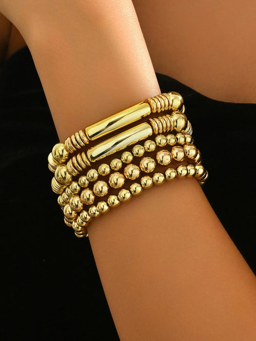 Gold 5-piece beaded bracelet set with stacked bead rows on wrist