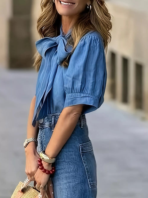 Dusty blue bow-tie blouse with short puff sleeves and gathered shoulders