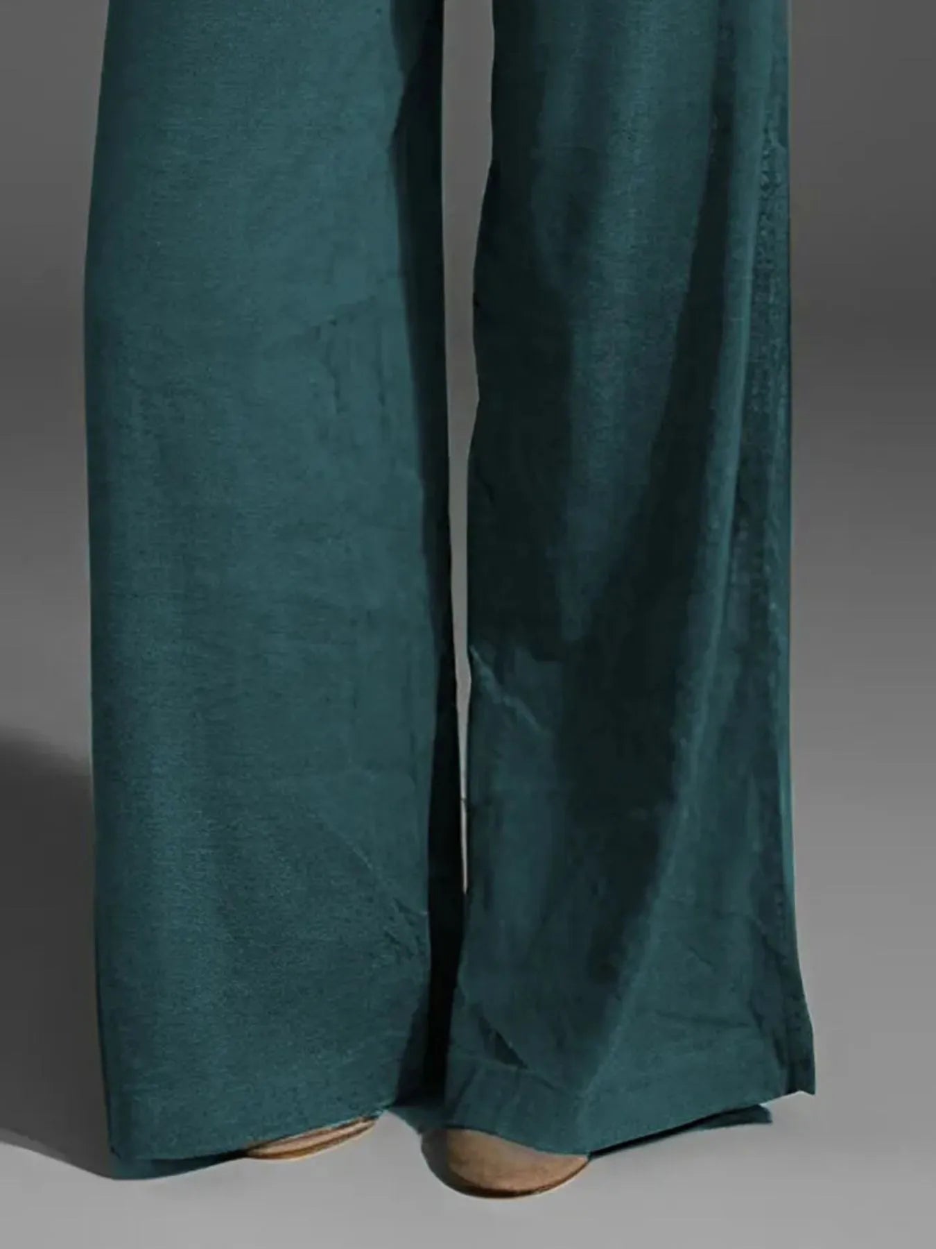 Deep teal wide-leg pants with side pockets and flowing wide legs