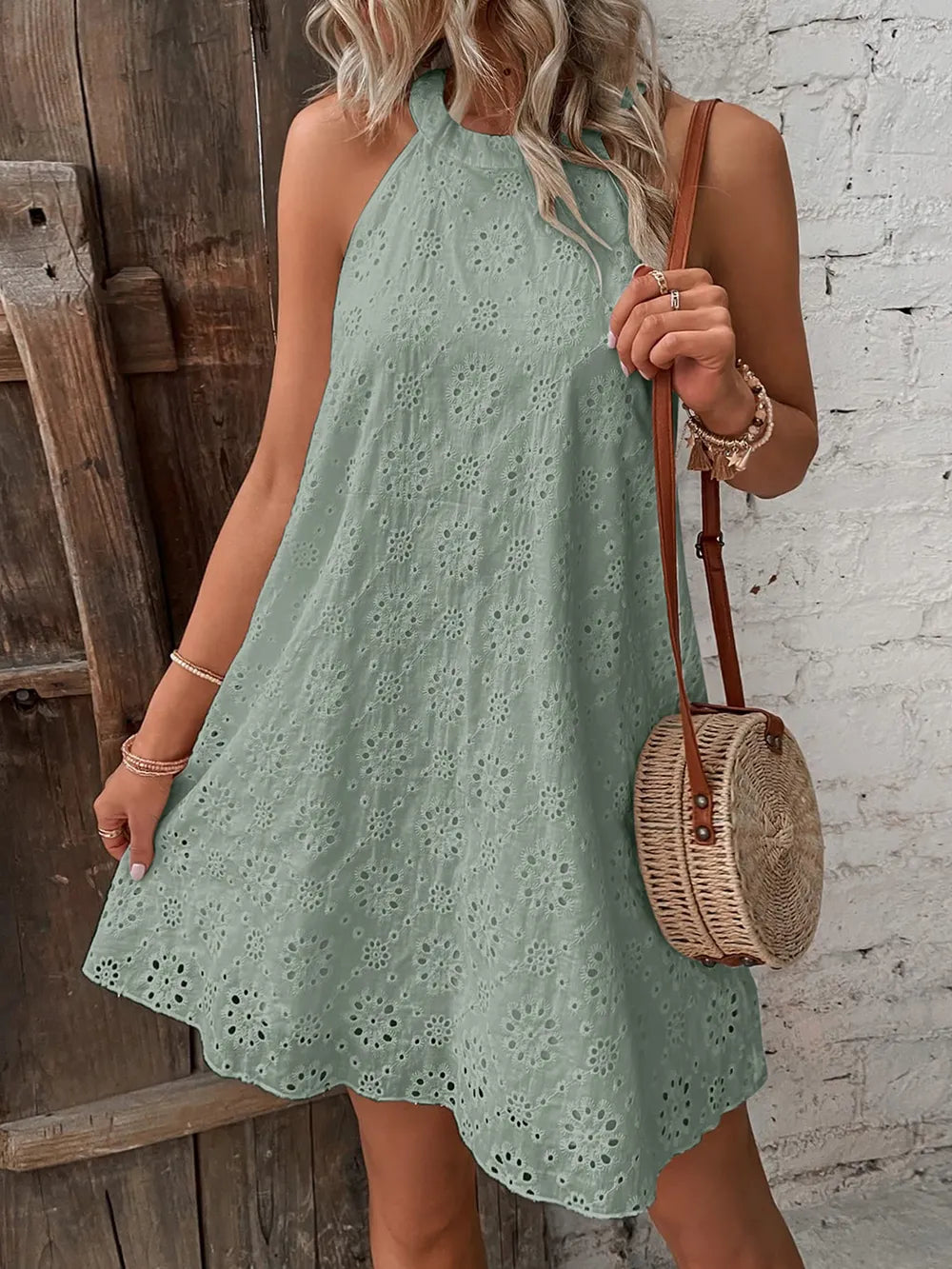 Sage green eyelet mini dress, sleeveless with Grecian neckline and embroidered eyelets