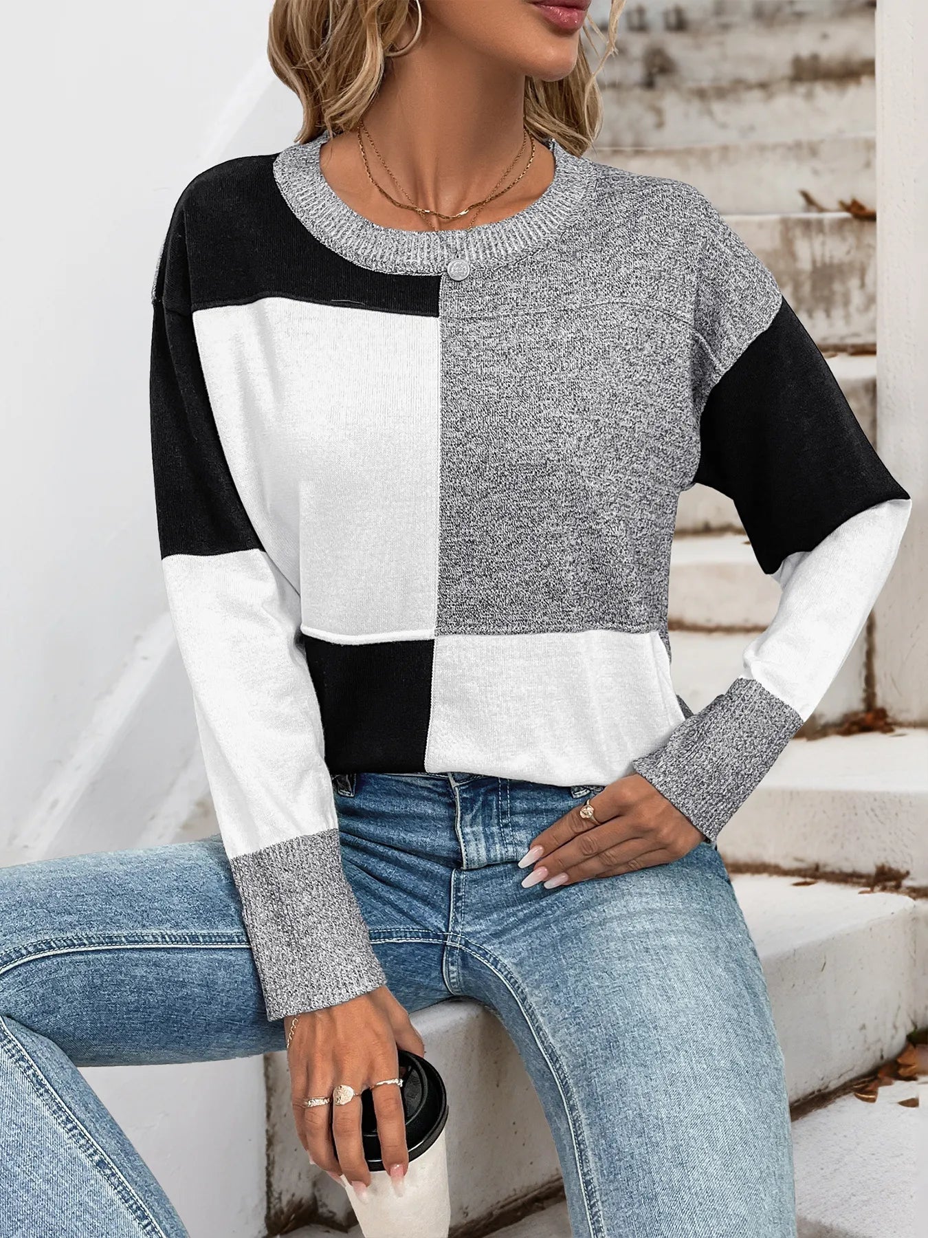 Grey, black, and white color-block knit long-sleeve sweater with ribbed crew neck