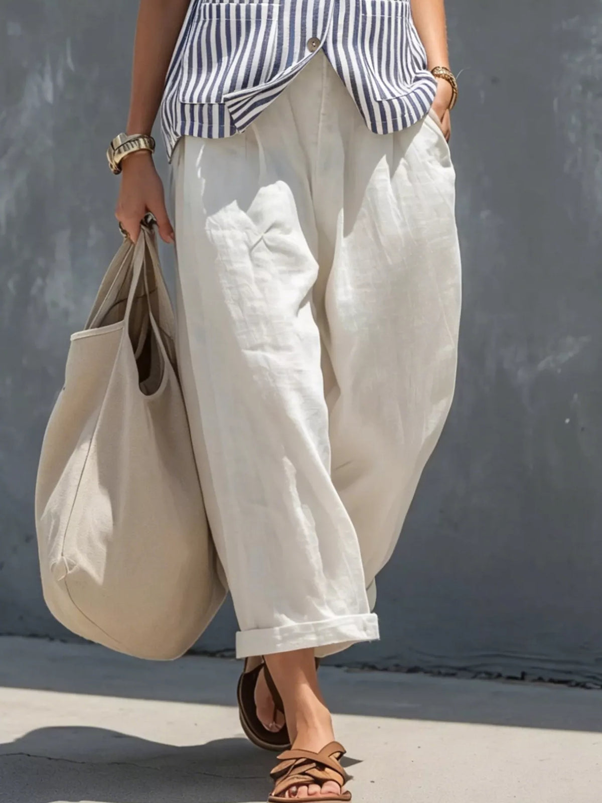 Blue striped sleeveless vest and white cropped pants with side pockets