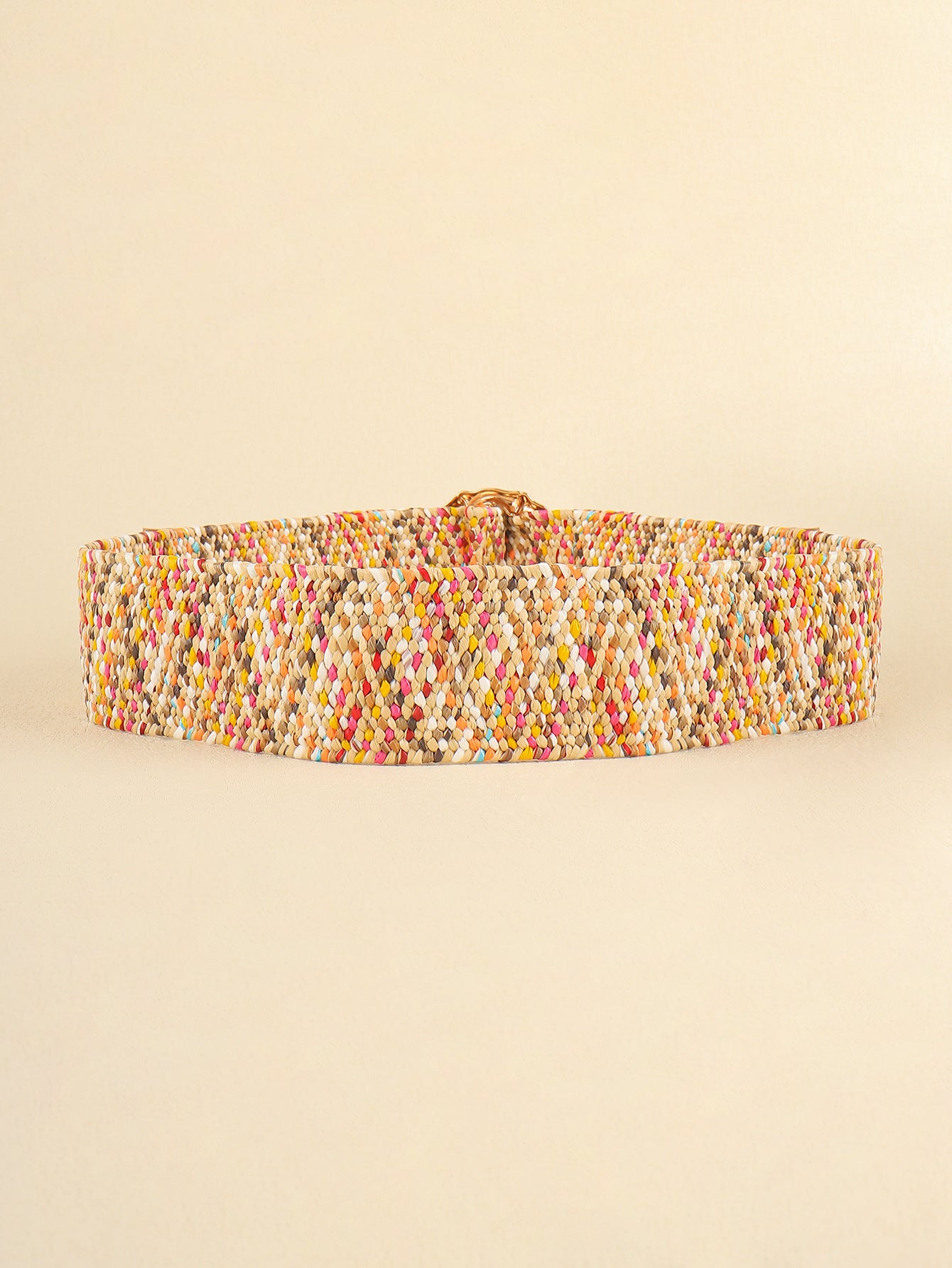 Multicolored wide belt, flat woven strap with tan leather backing near buckle