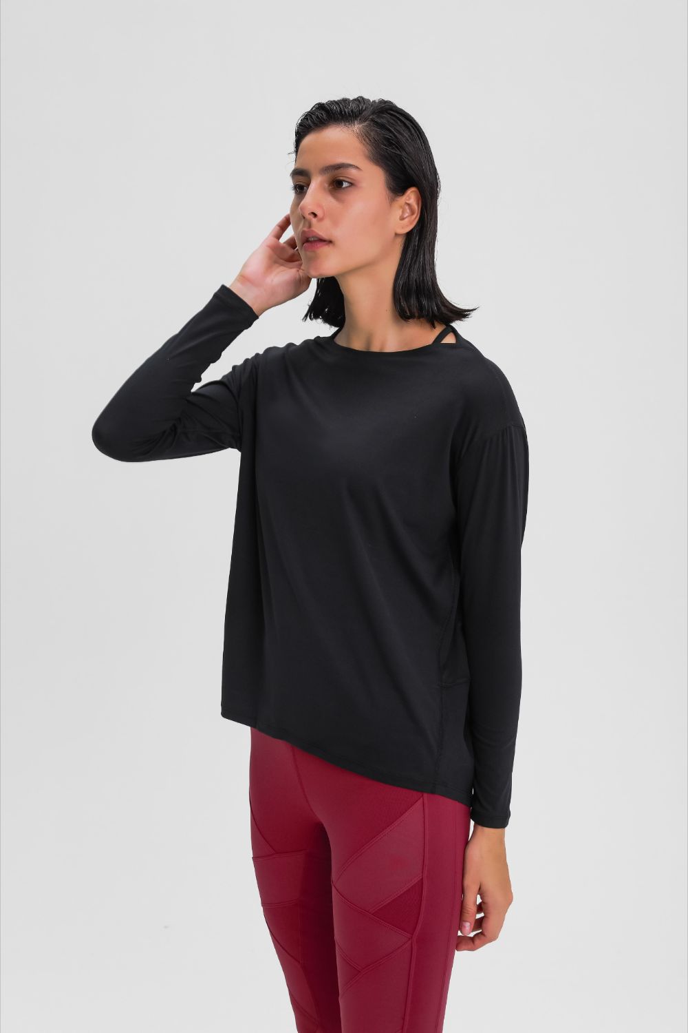 Loose fit active top in black, long sleeves with relaxed shoulder and crew neckline.