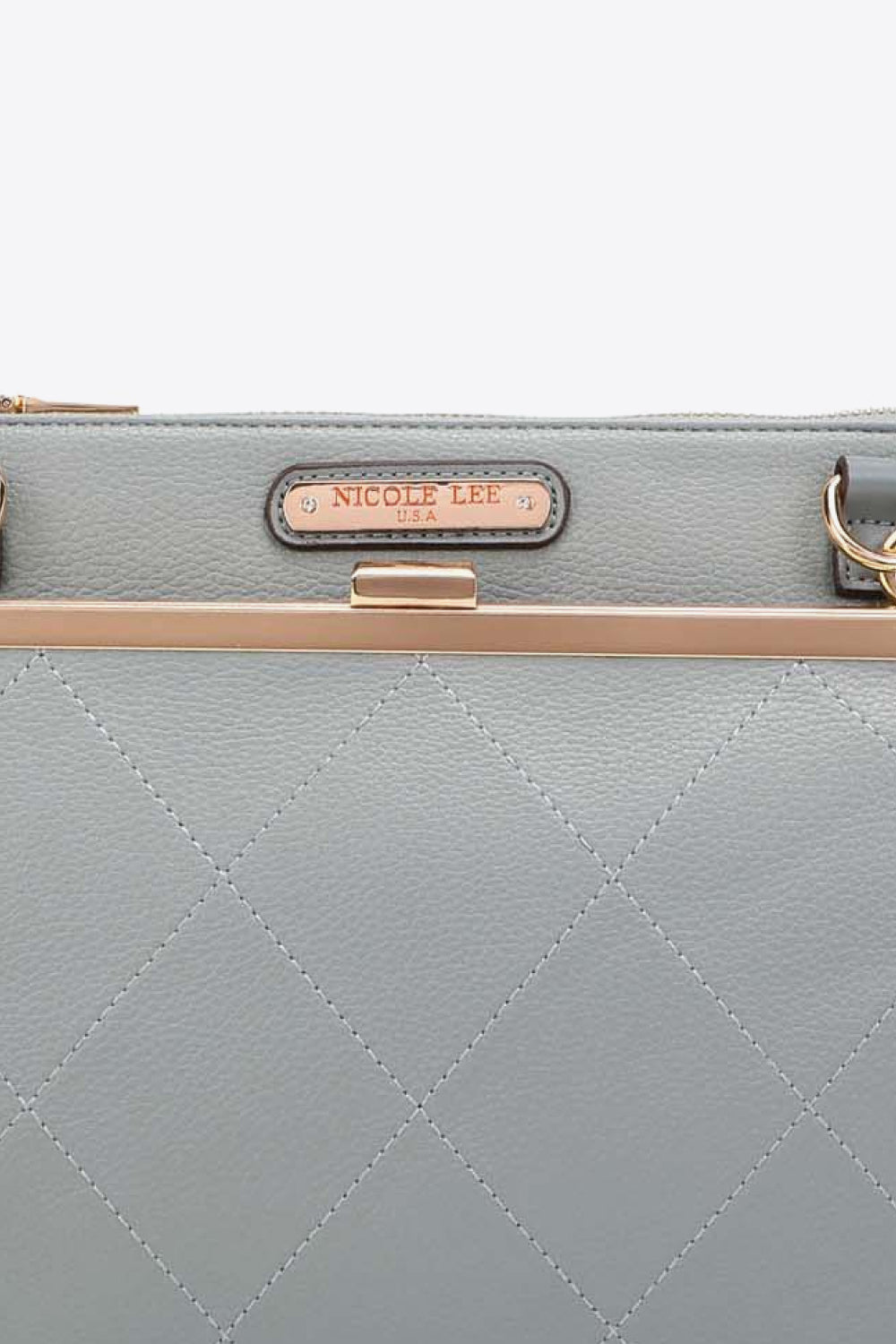 Light gray quilted handbag front with Nicole Lee USA label and top clasp
