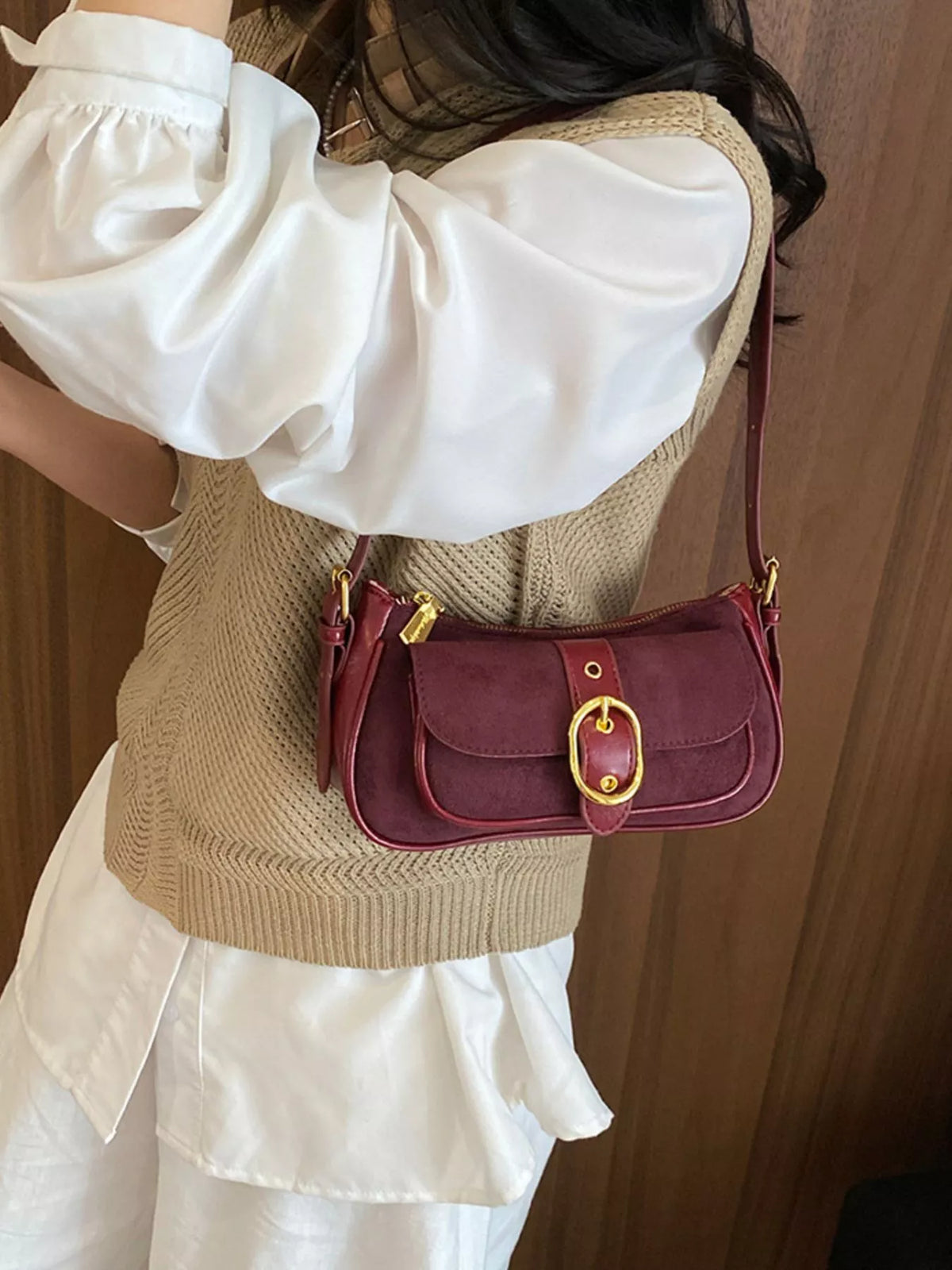 Wine red suede shoulder bag with front flap and gold-tone buckle clasp