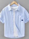 Mens blue striped short-sleeve button-up cotton shirt with chest pocket and logo