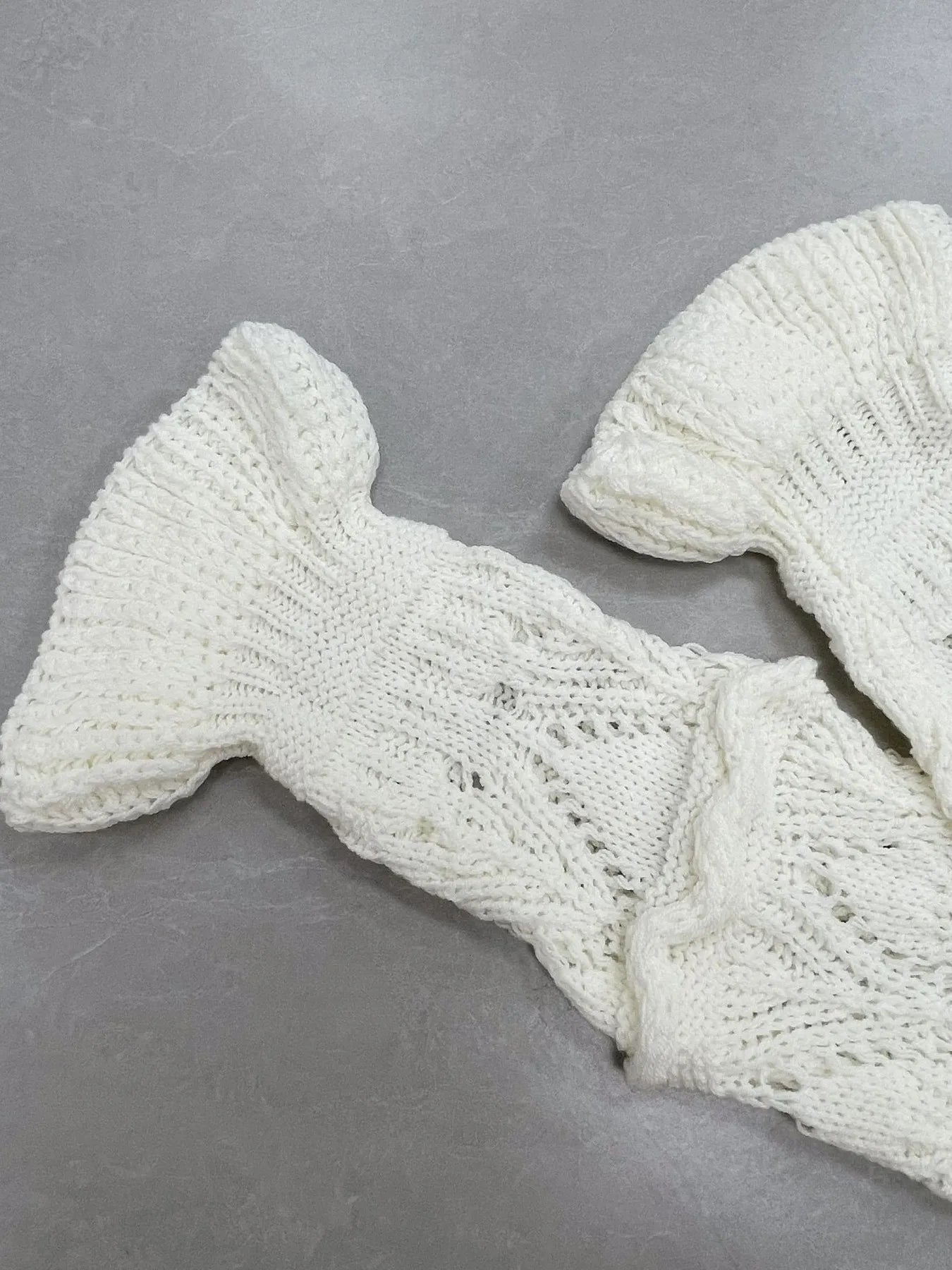 White crochet long sleeve sweater sleeve with openwork stitch texture and cuff