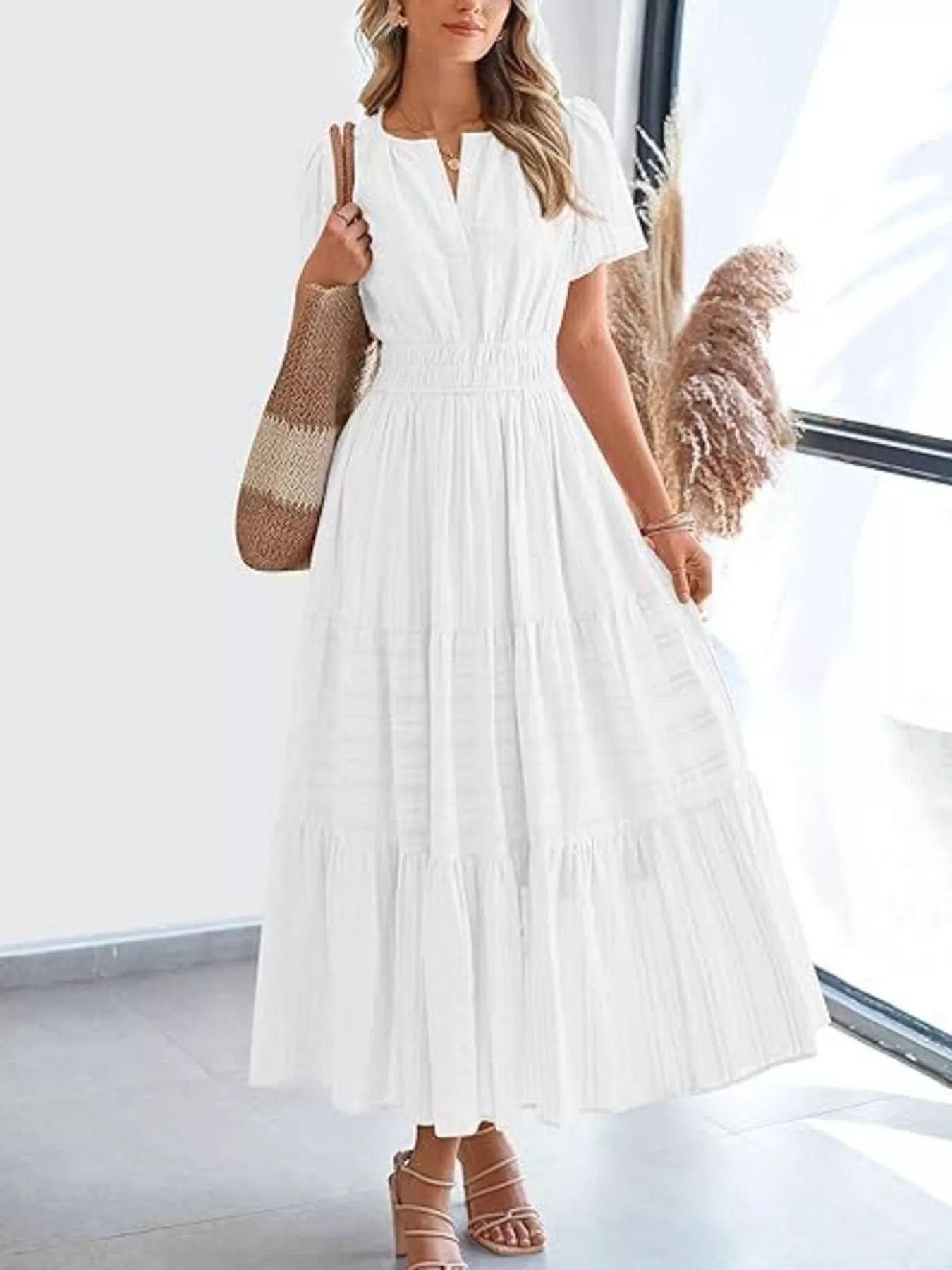 White tiered midi dress with short sleeves and V-neck, gathered at the waist