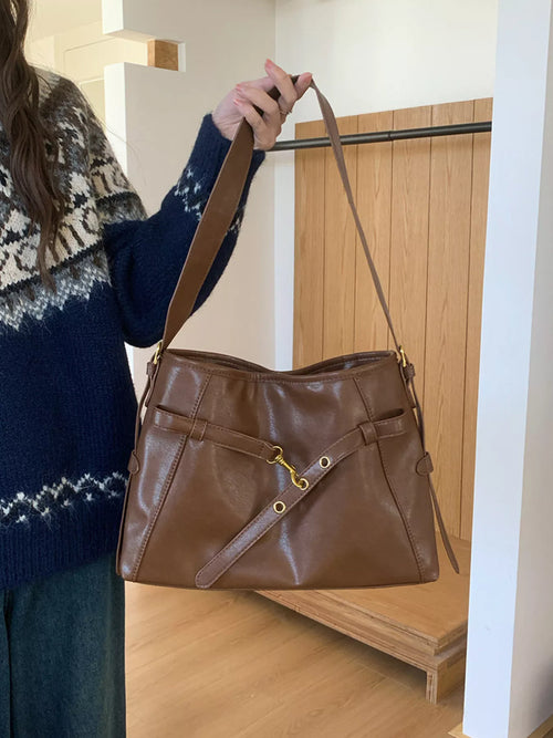 Coffee brown buckle-detail tote bag with top handles and crossbody strap
