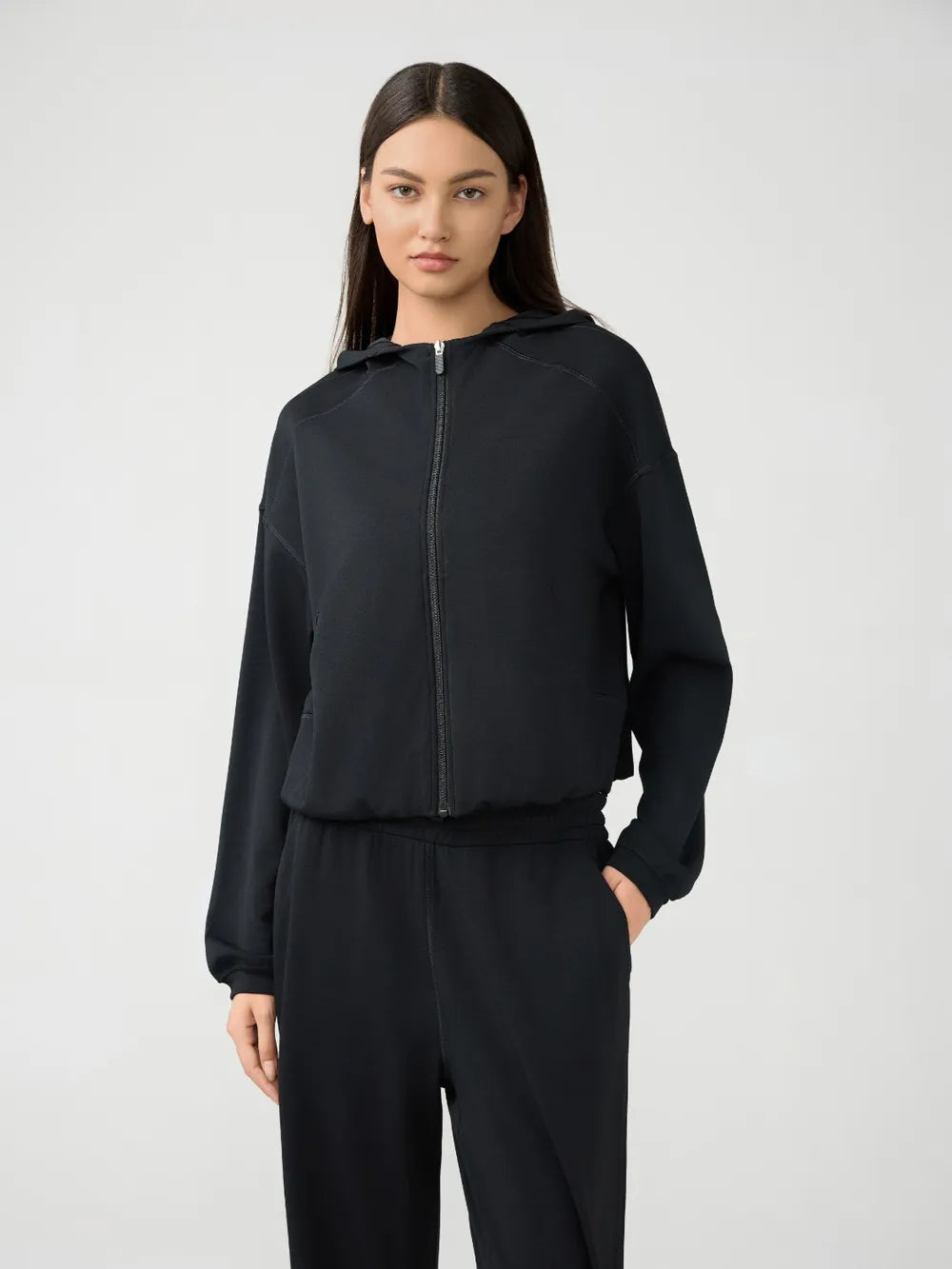 Black zip-up hooded active jacket with dropped shoulders and front zipper