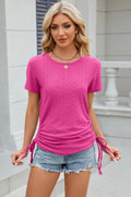 Hot pink eyelet round-neck short-sleeve T-shirt with center button detail