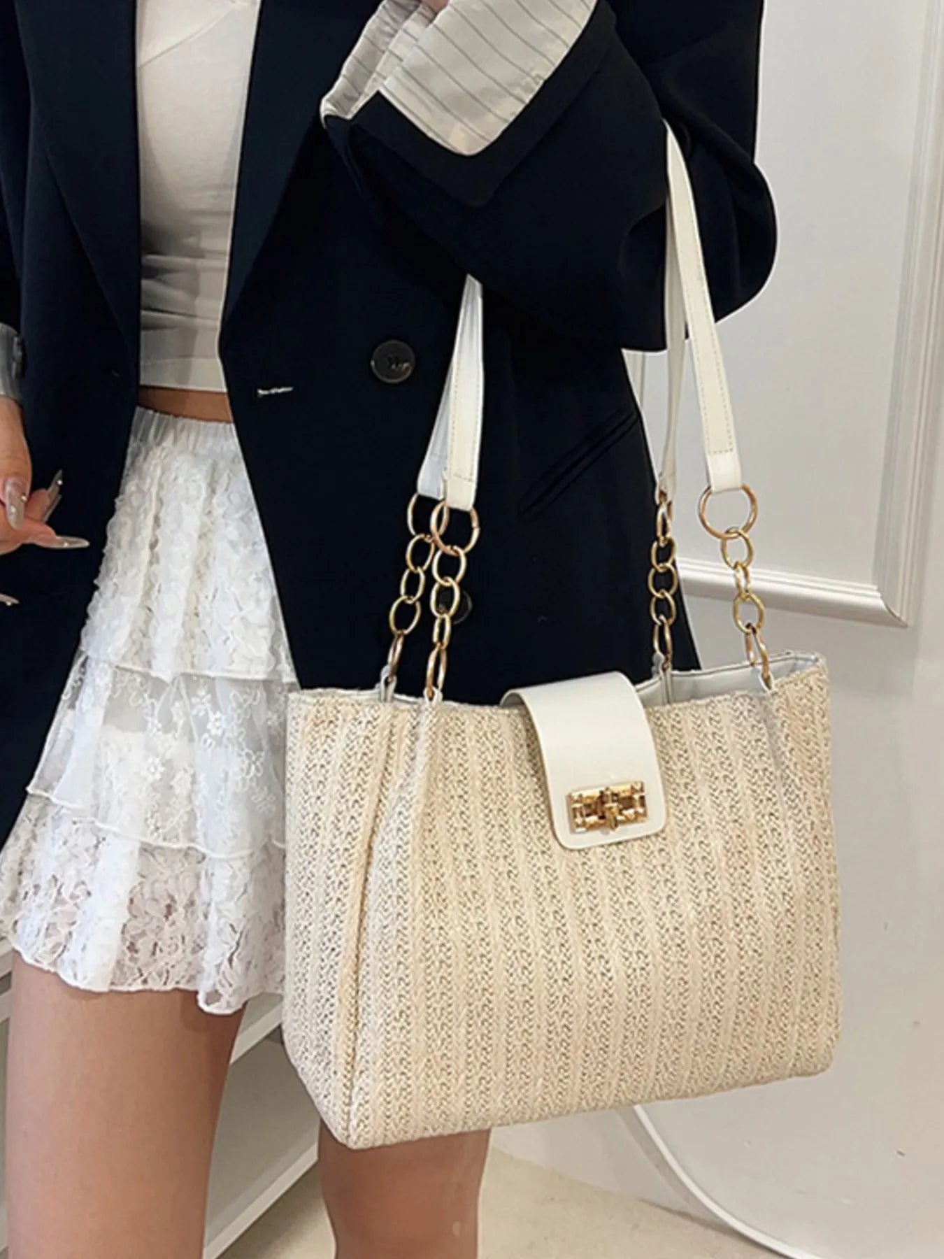 Beige woven straw shoulder bag with gold chain handles and square front flap clasp