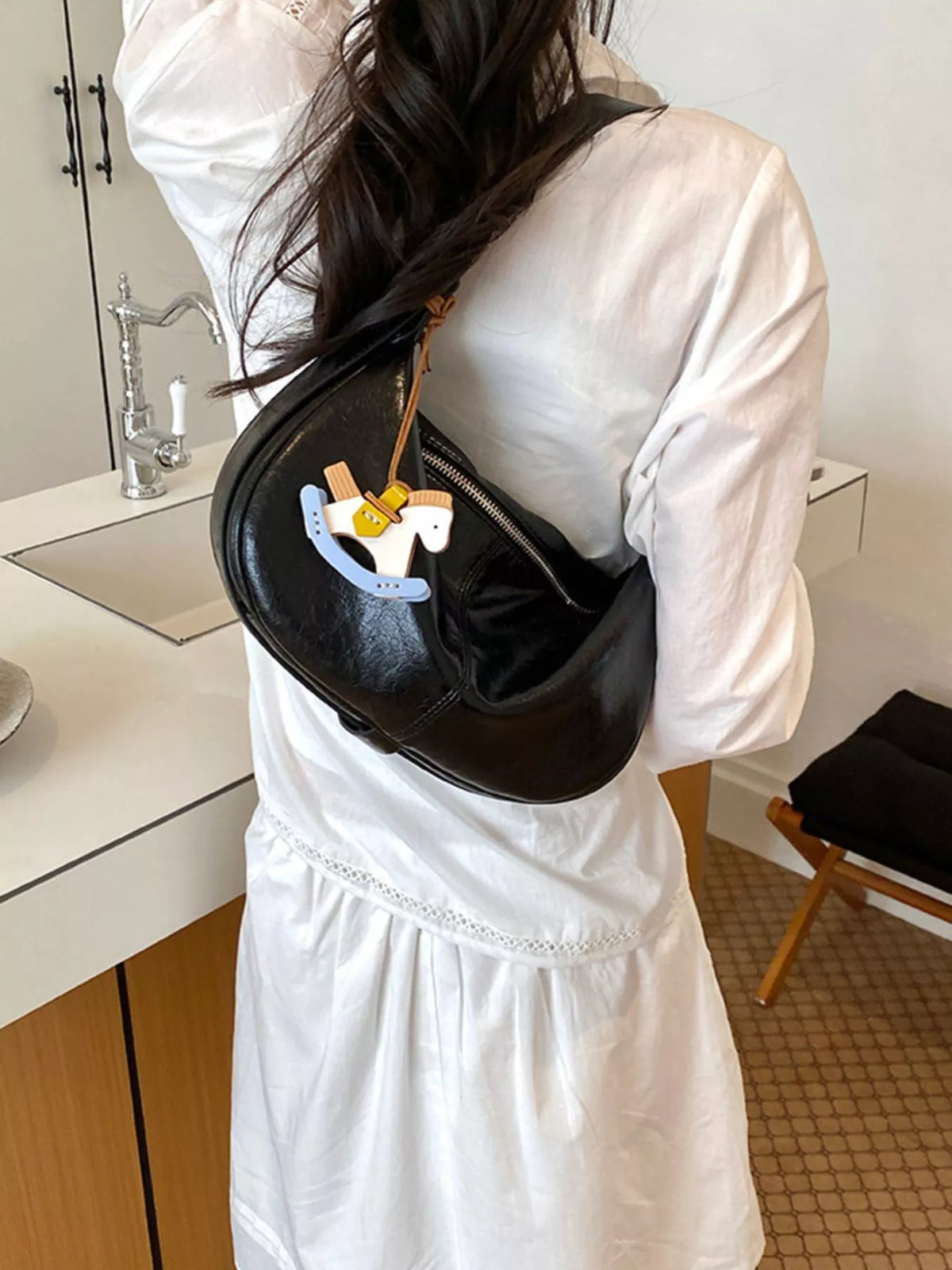 Black vegan leather crescent crossbody bag, medium size, zippered top