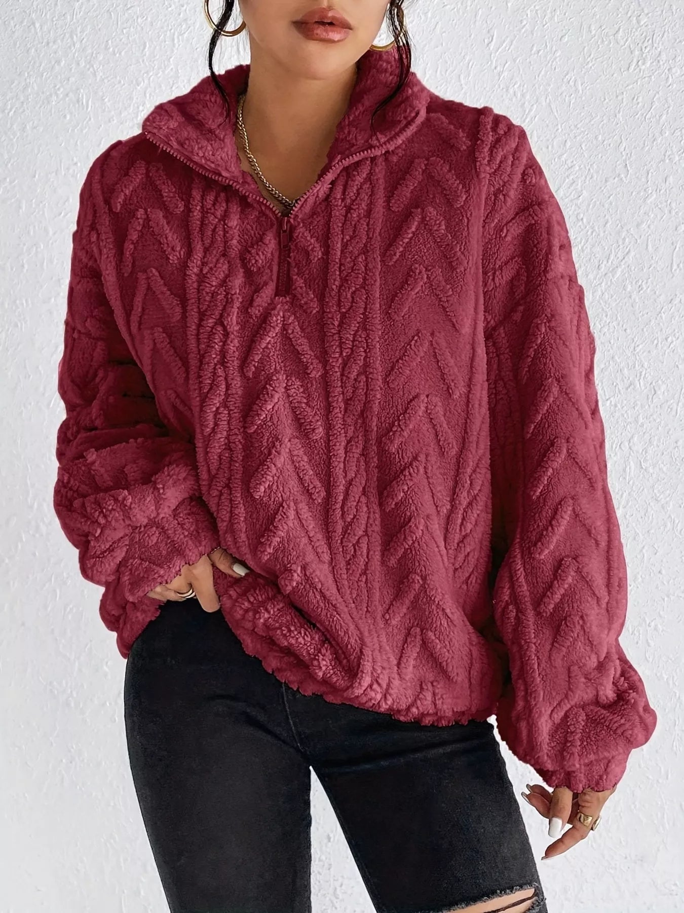 Burgundy sherpa quarter-zip sweatshirt with cable-knit texture and dropped shoulders