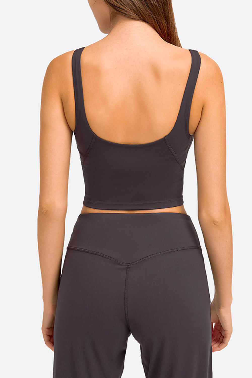 Deep V-neck crop sports bra with racerback, dark gray-black color.