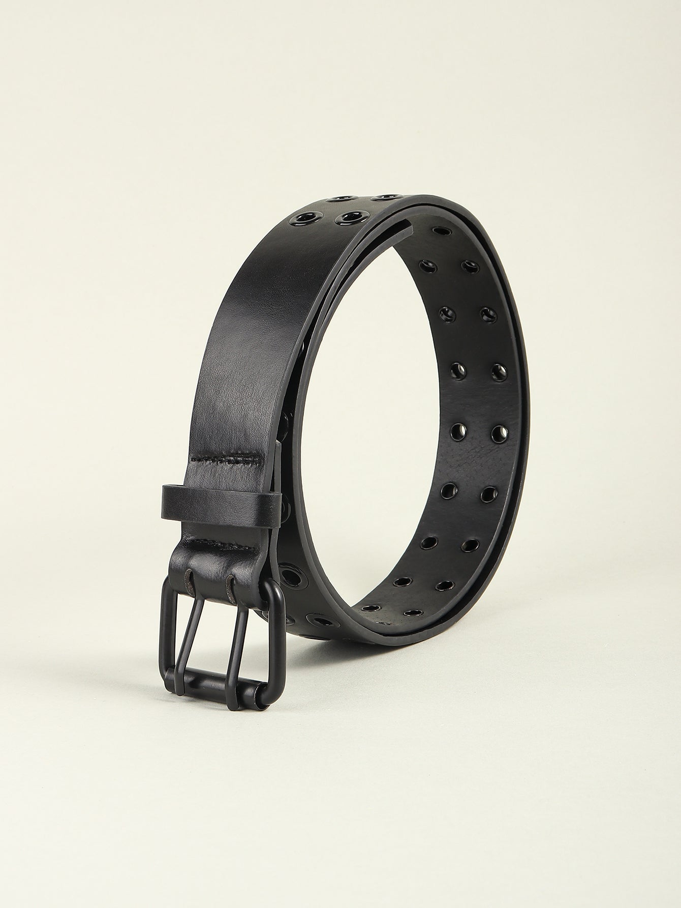 Black vegan leather belt with metal eyelet row and square buckle loop detail.