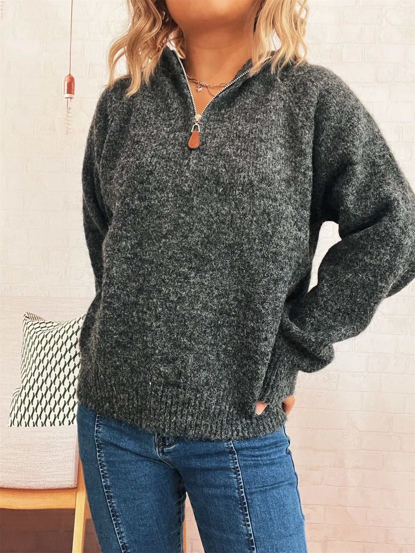 Dark gray quarter-zip knit sweater with ribbed hem and long sleeves