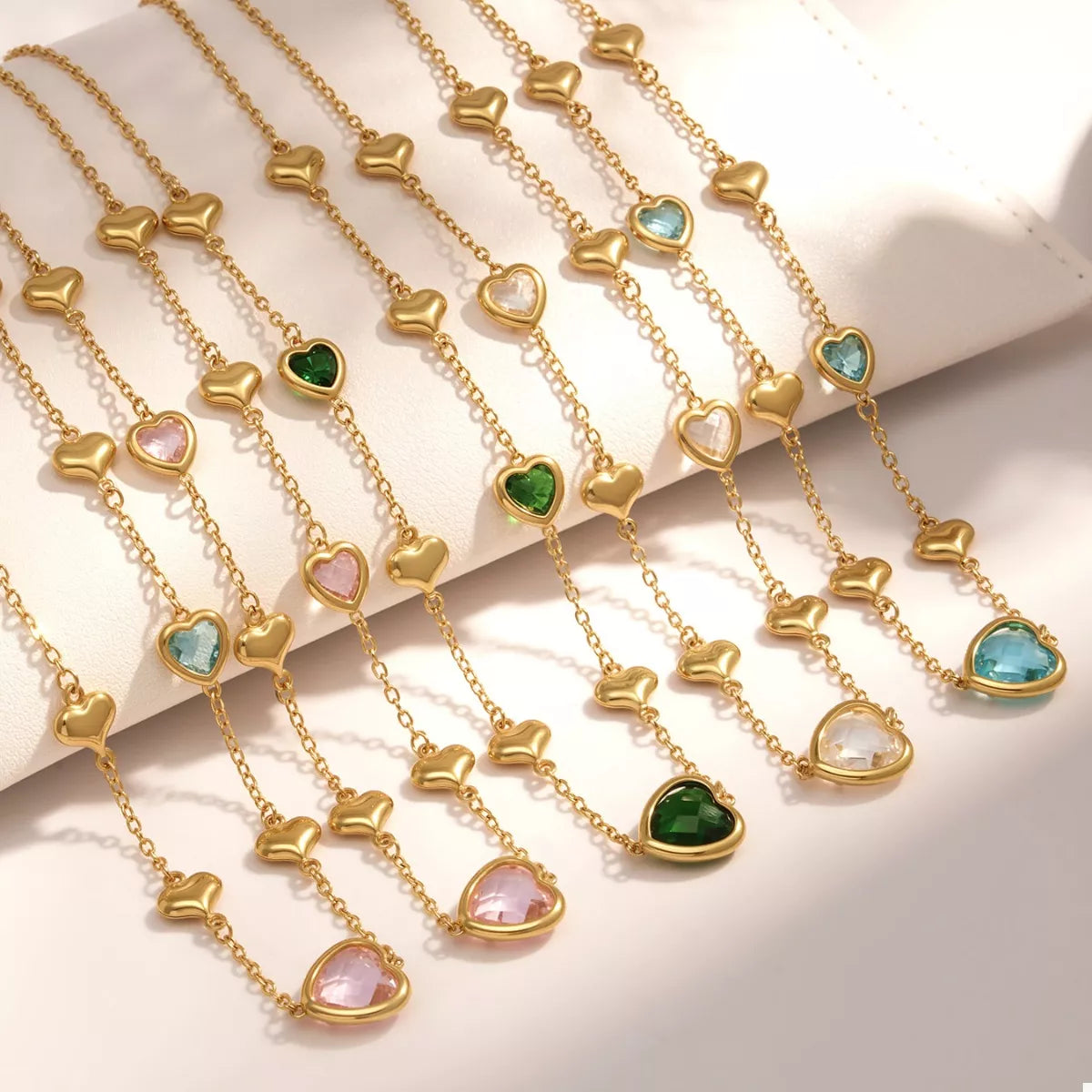 Gold-plated heart necklace set with assorted glass heart charms in gold frames