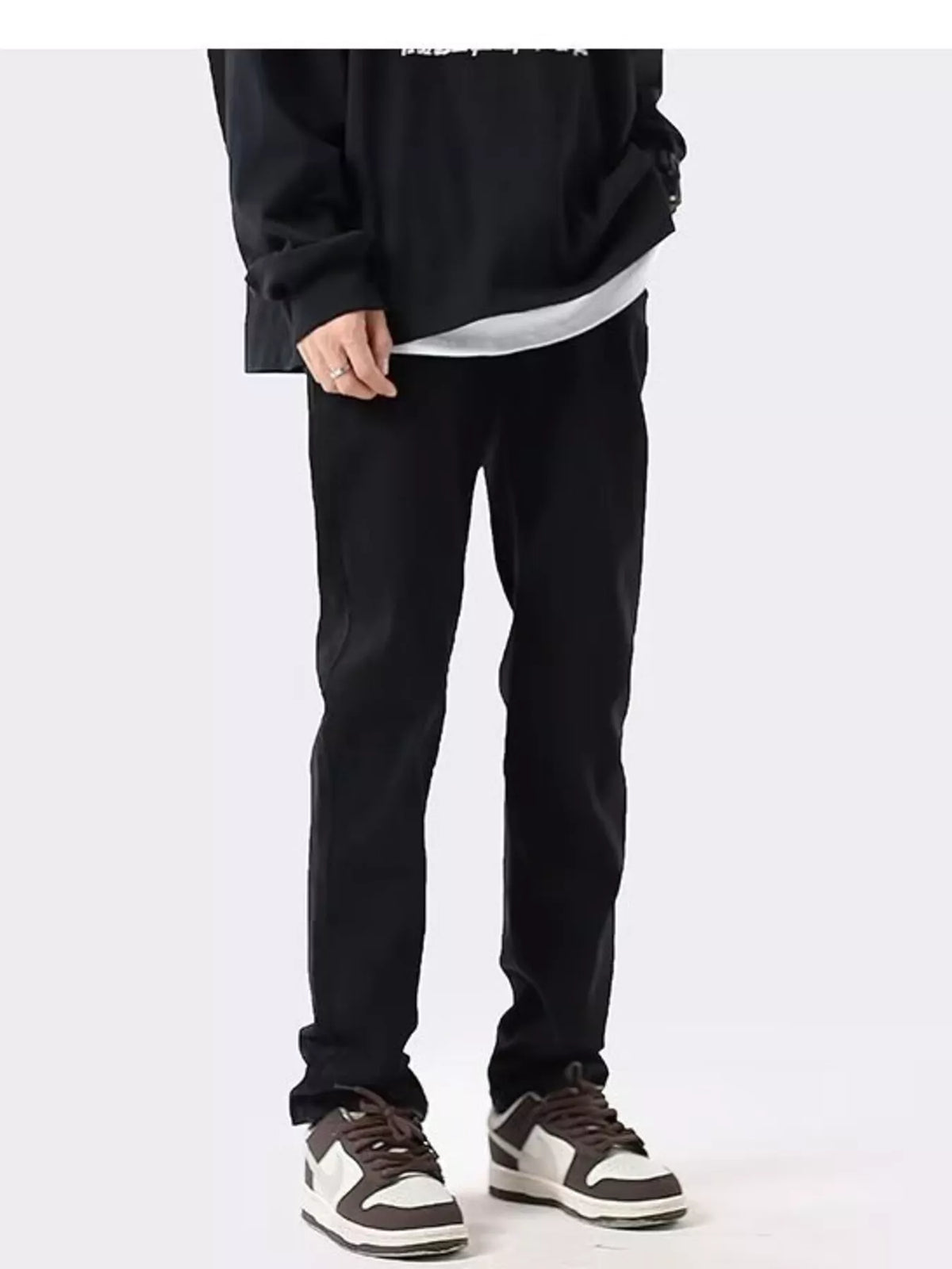 Black slim-fit cotton stretch jeans, straight tapered legs and cuffed hem