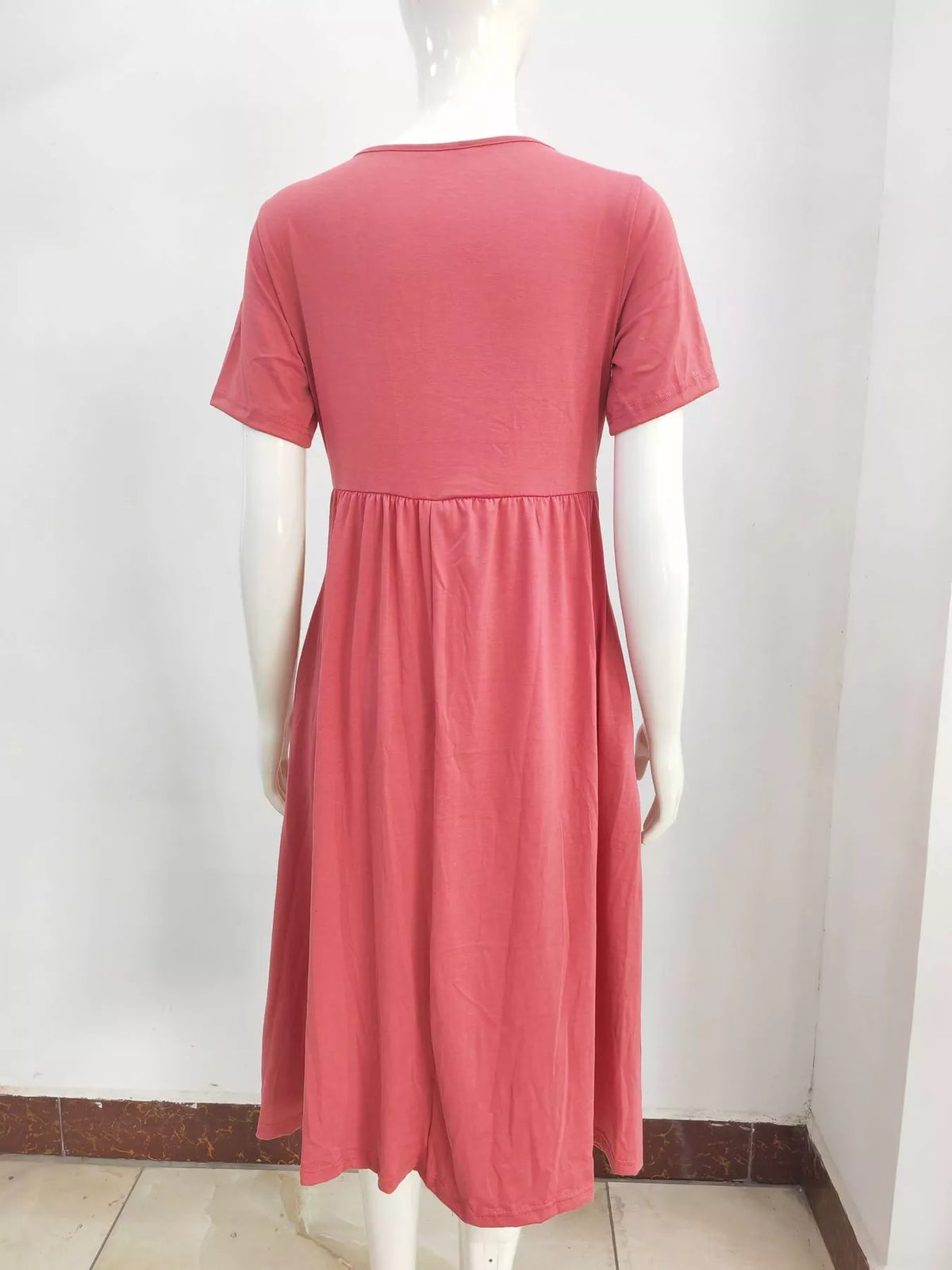 Watermelon red short-sleeve midi dress on mannequin, back view with gathered waist