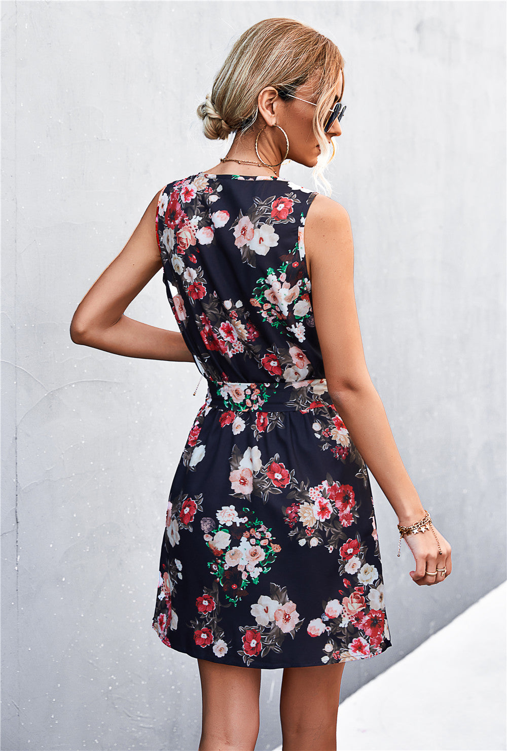 Dark floral sleeveless dress with tie waist, back view