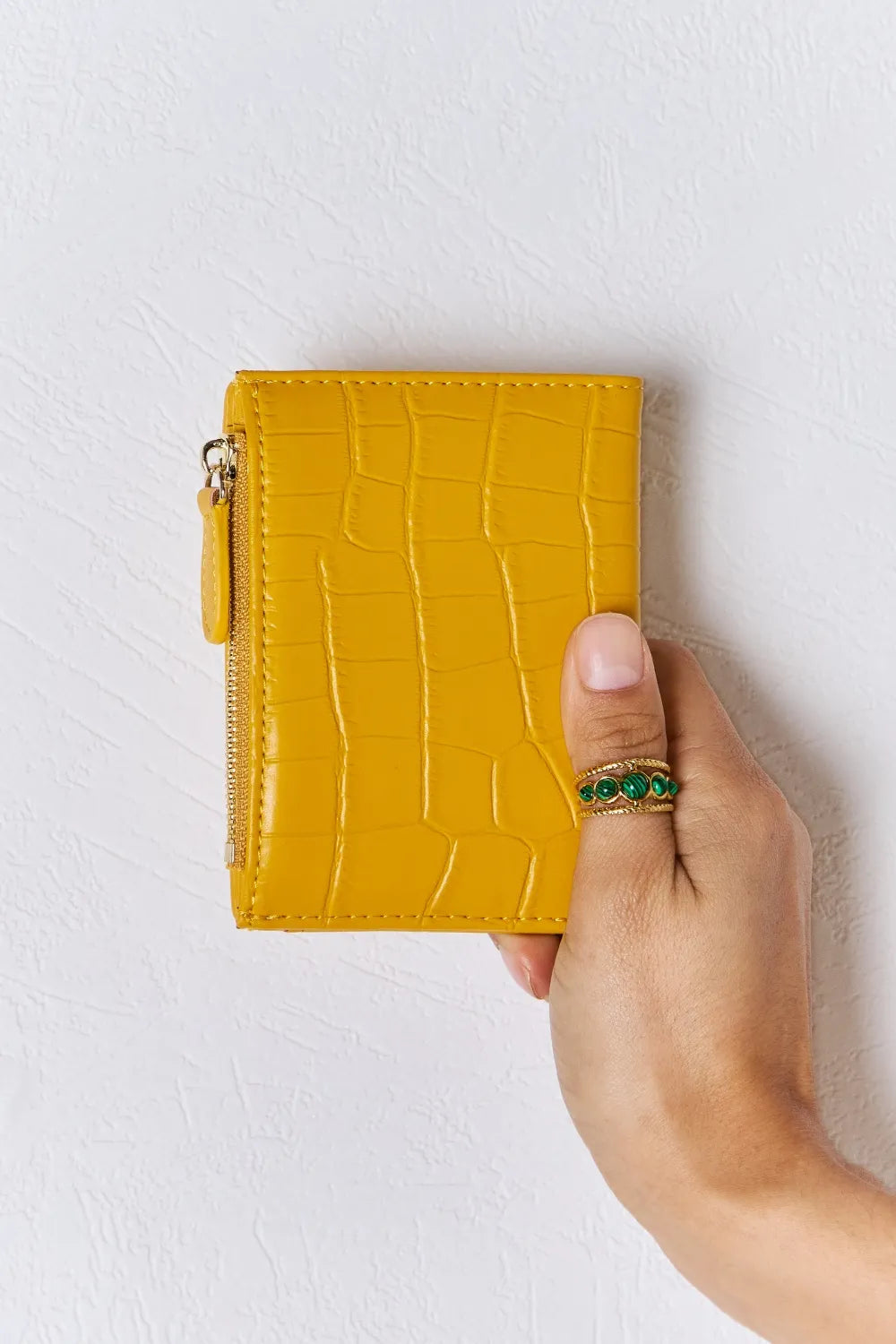 Yellow textured vegan leather mini wallet with gold-tone zipper and ring handle