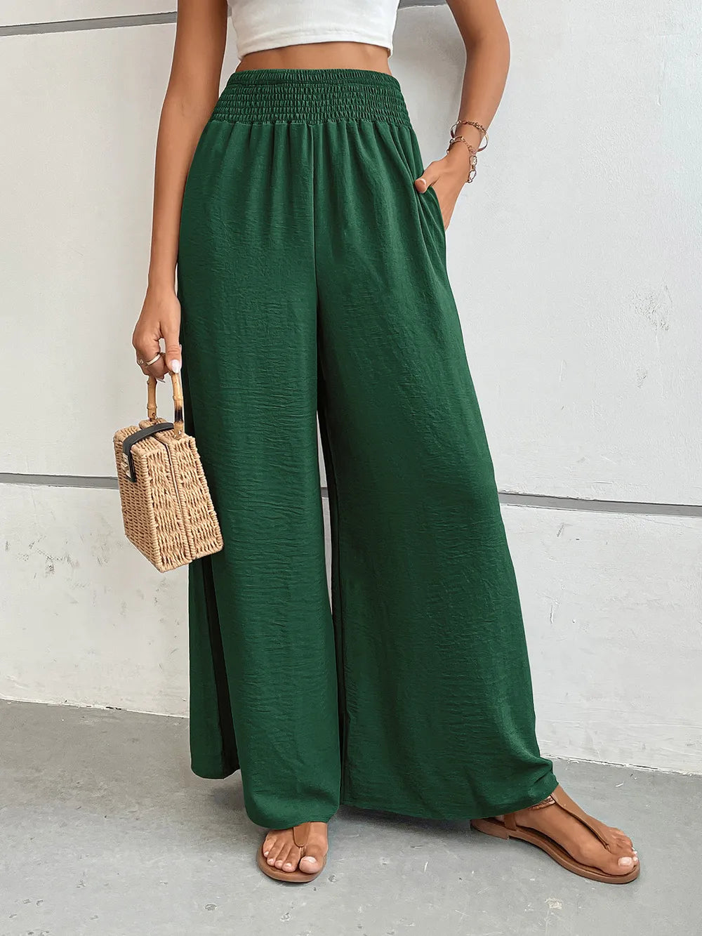 Wide-leg pants in dark green with elastic waistband, draped straight legs