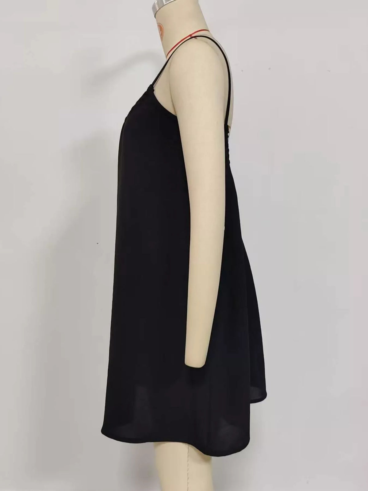 Black backless mini dress with spaghetti straps and flowing A-line skirt