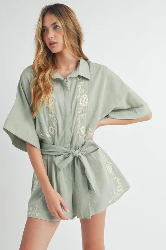 Dusty sage embroidered button-up collared romper with tie waist and short sleeves
