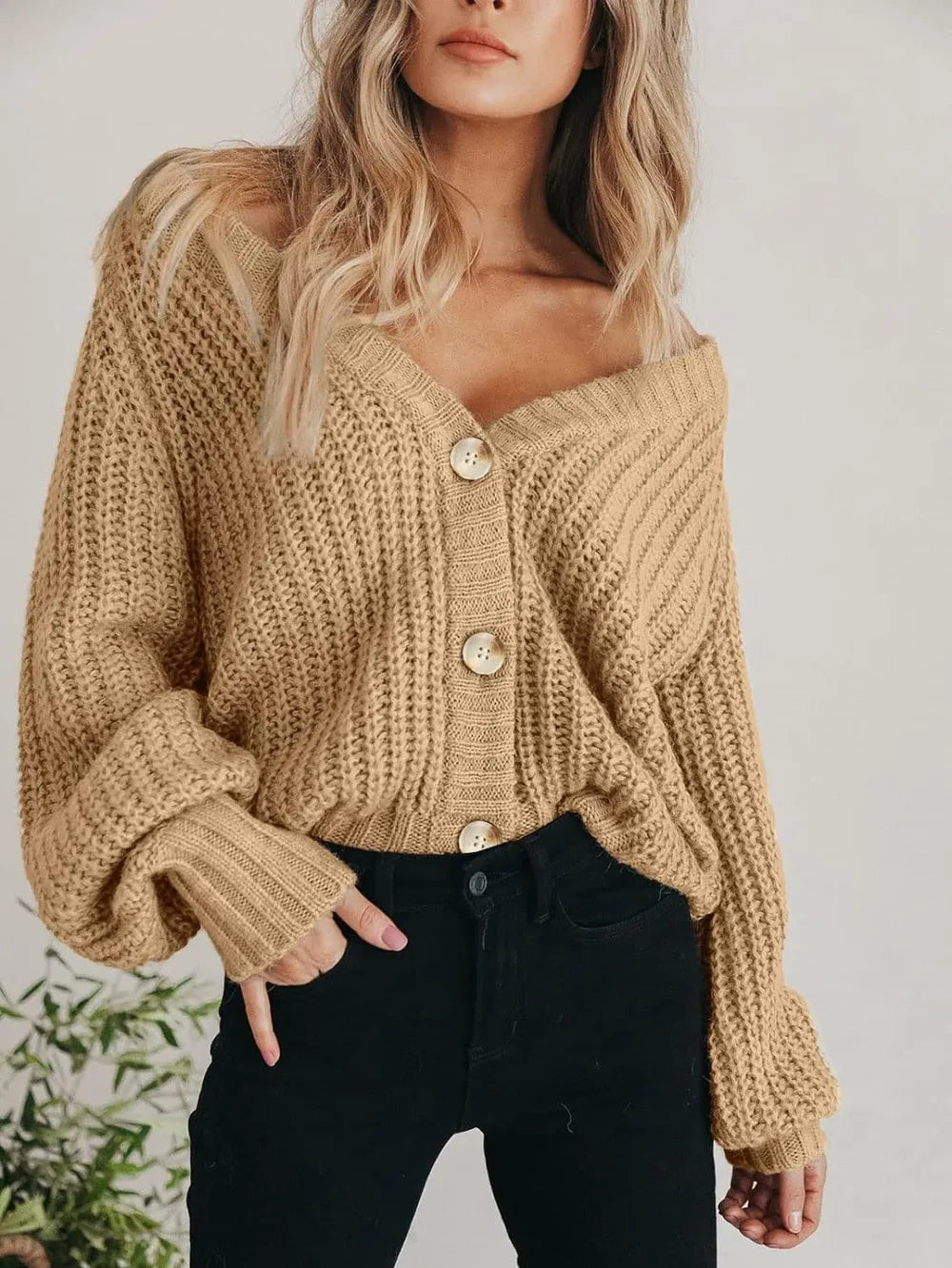 Light tan chunky knit cardigan with long sleeves, V-neck, and button-front closure