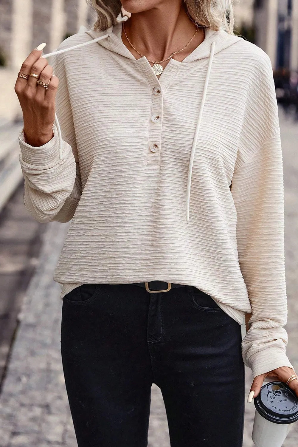 Ivory drawstring hoodie with half-button placket and long dropped sleeves
