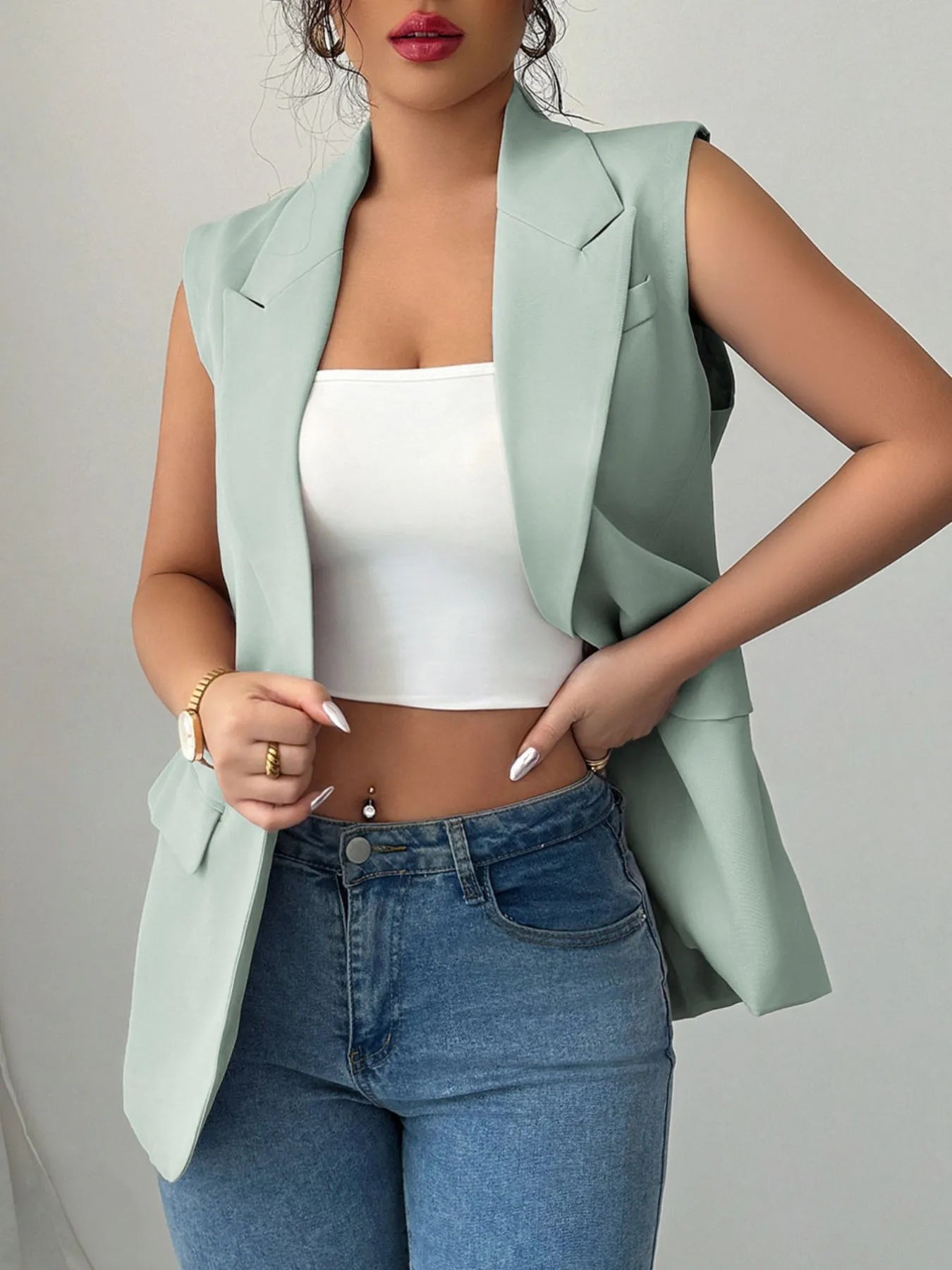 Sage sleeveless blazer with one button and flap pockets