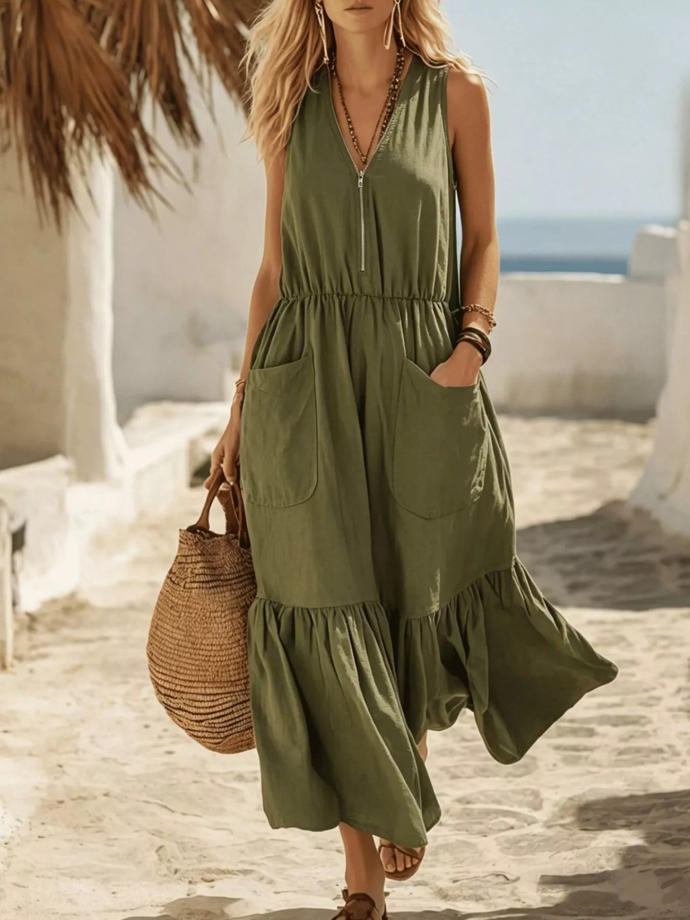Army green sleeveless maxi dress with zipper front, pockets, and ruffle hem