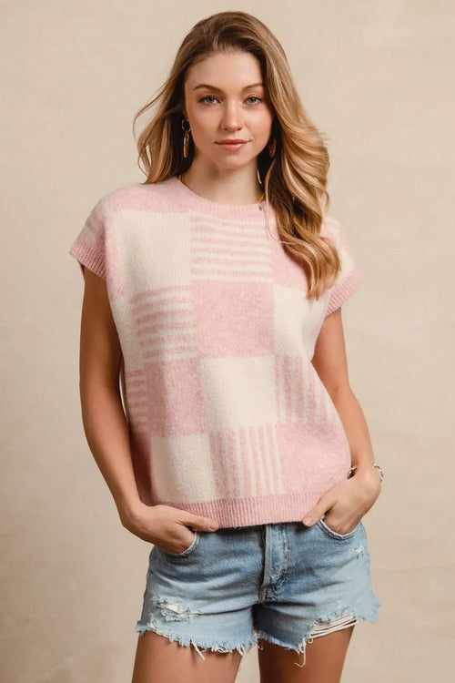 Blush and ivory sleeveless knit sweater vest with checker stripe pattern and ribbed hem