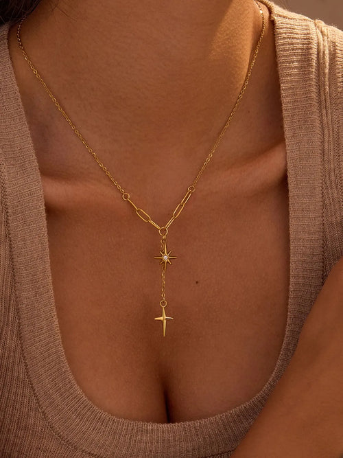 Gold-plated pendant necklace with star and cross charms on a fine chain