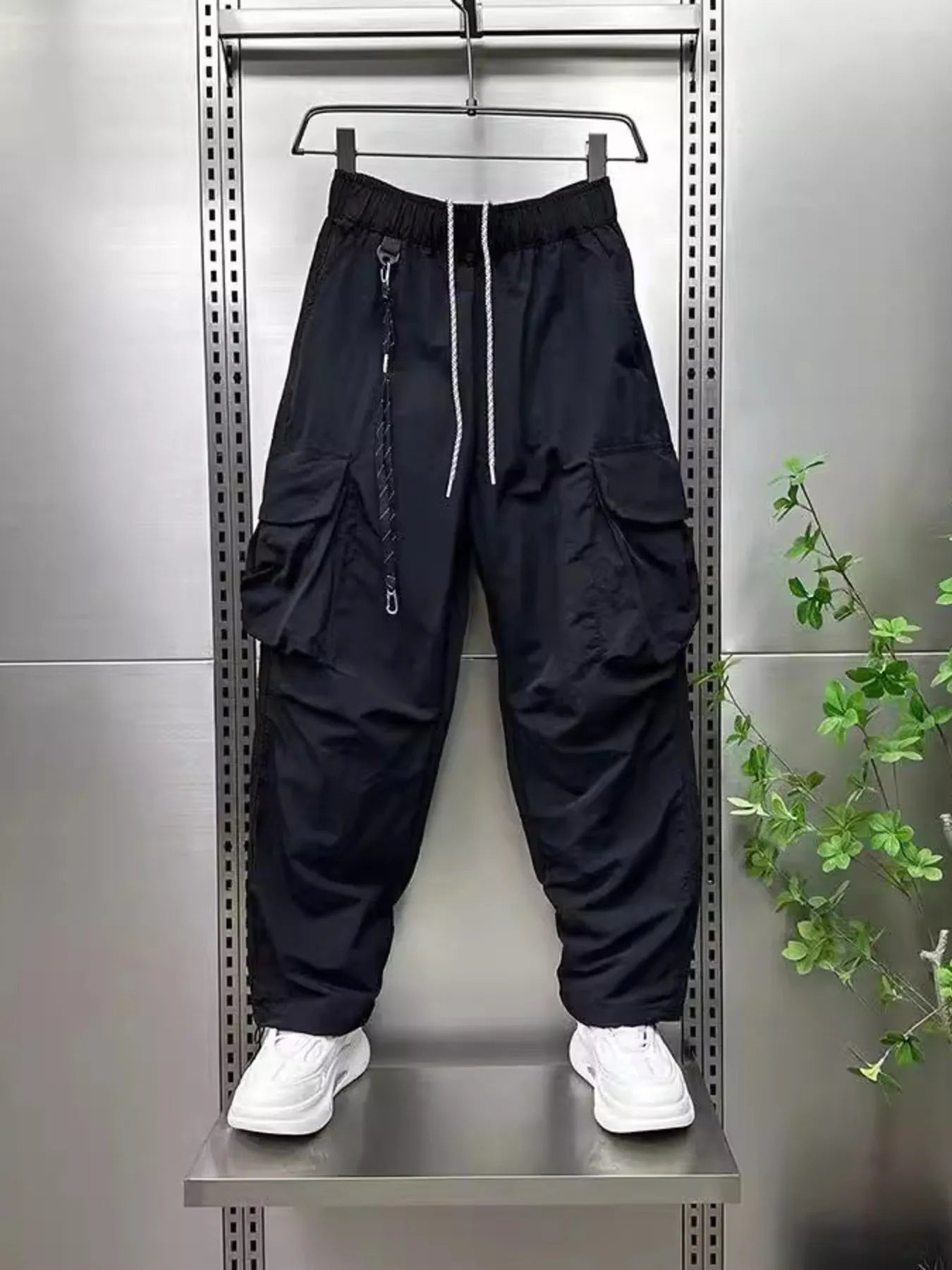 Men's plus size drawstring cargo pants, wide-leg, black with side cargo pockets.