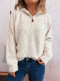 Light beige quarter-zip ribbed hem sweater with snap-style zipper pull