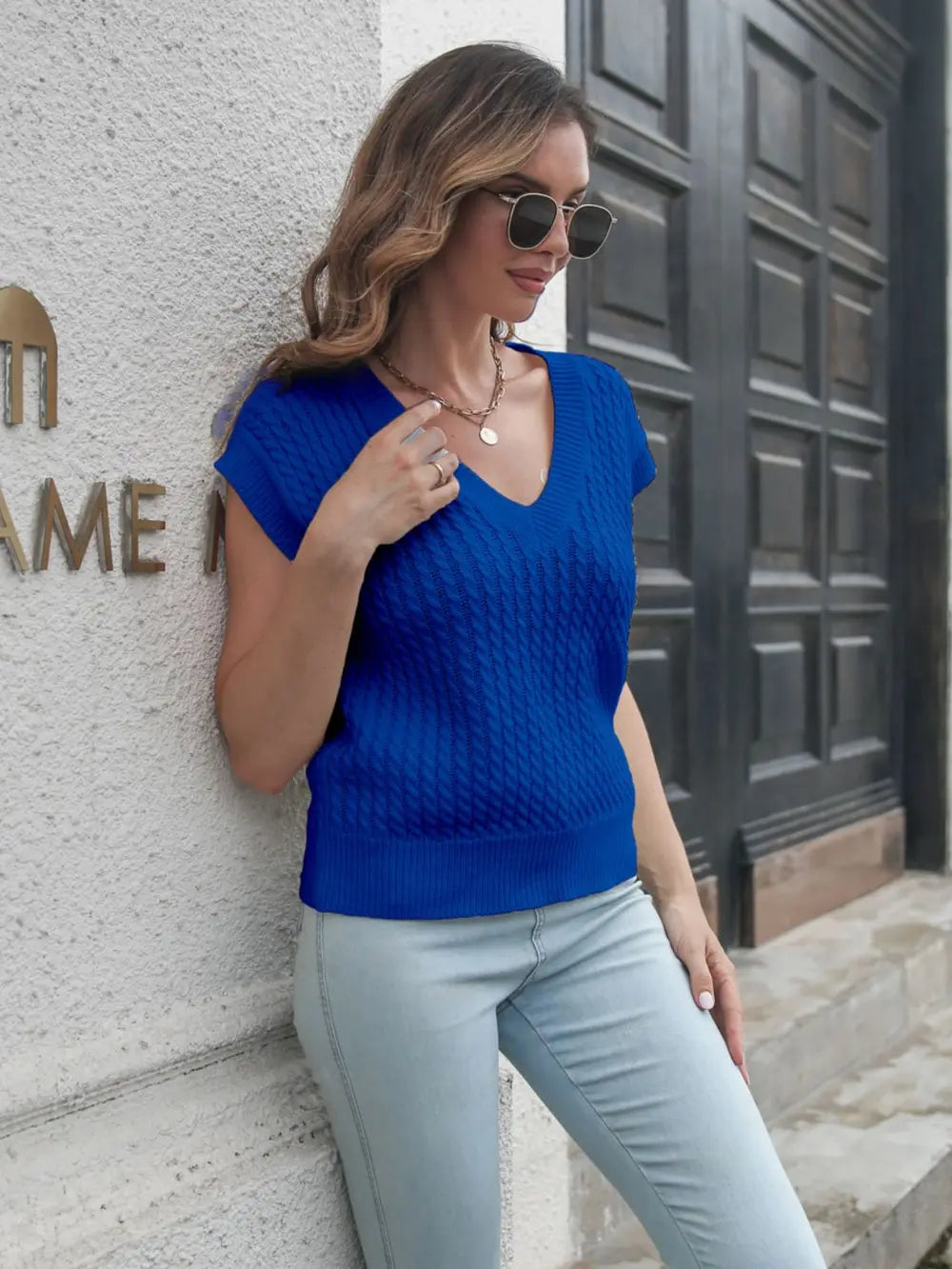 Cable-knit V-neck sweater vest, peacock blue, front view with V-neck and textured stitches.